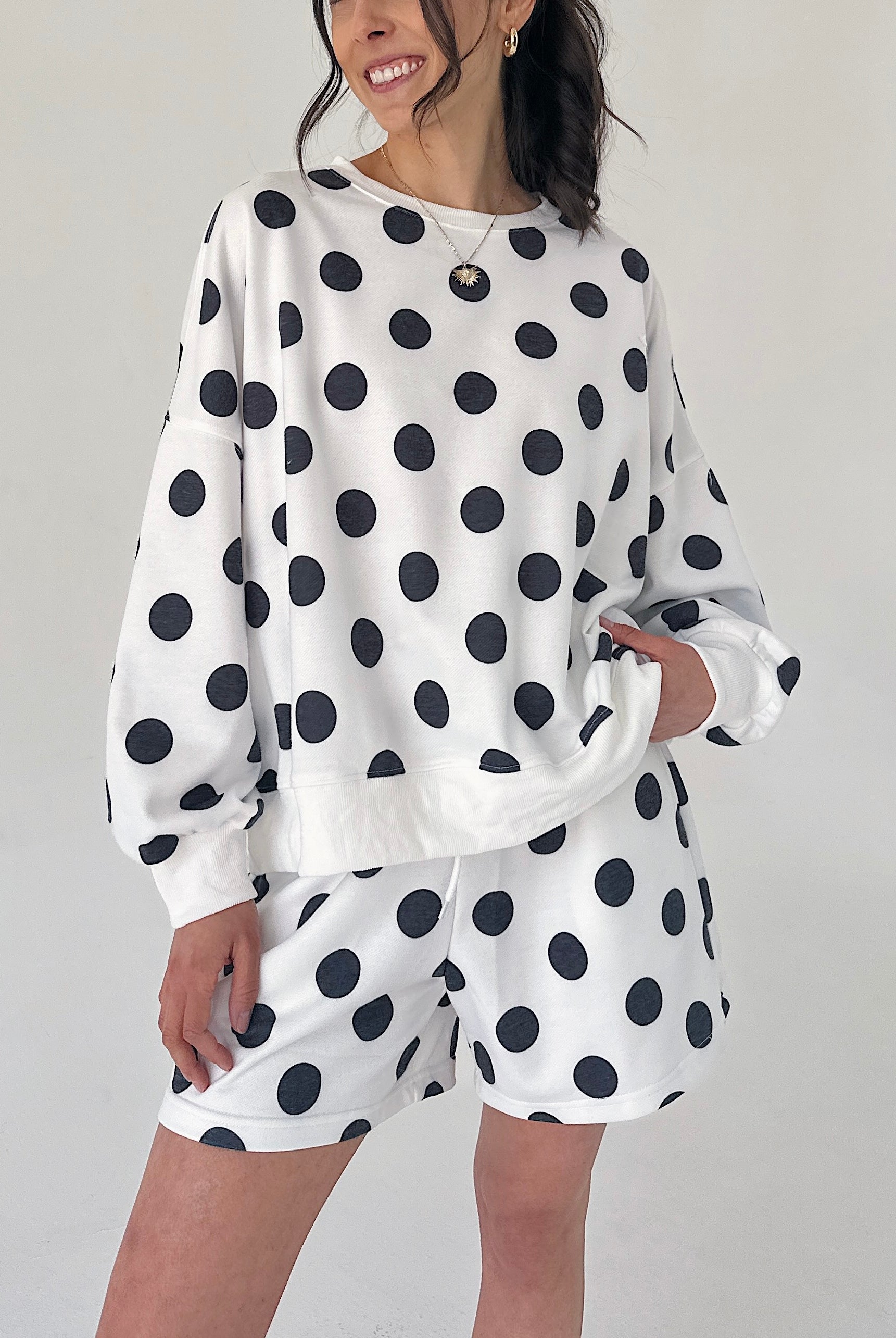 Person wearing a polka dot outfit with a white background