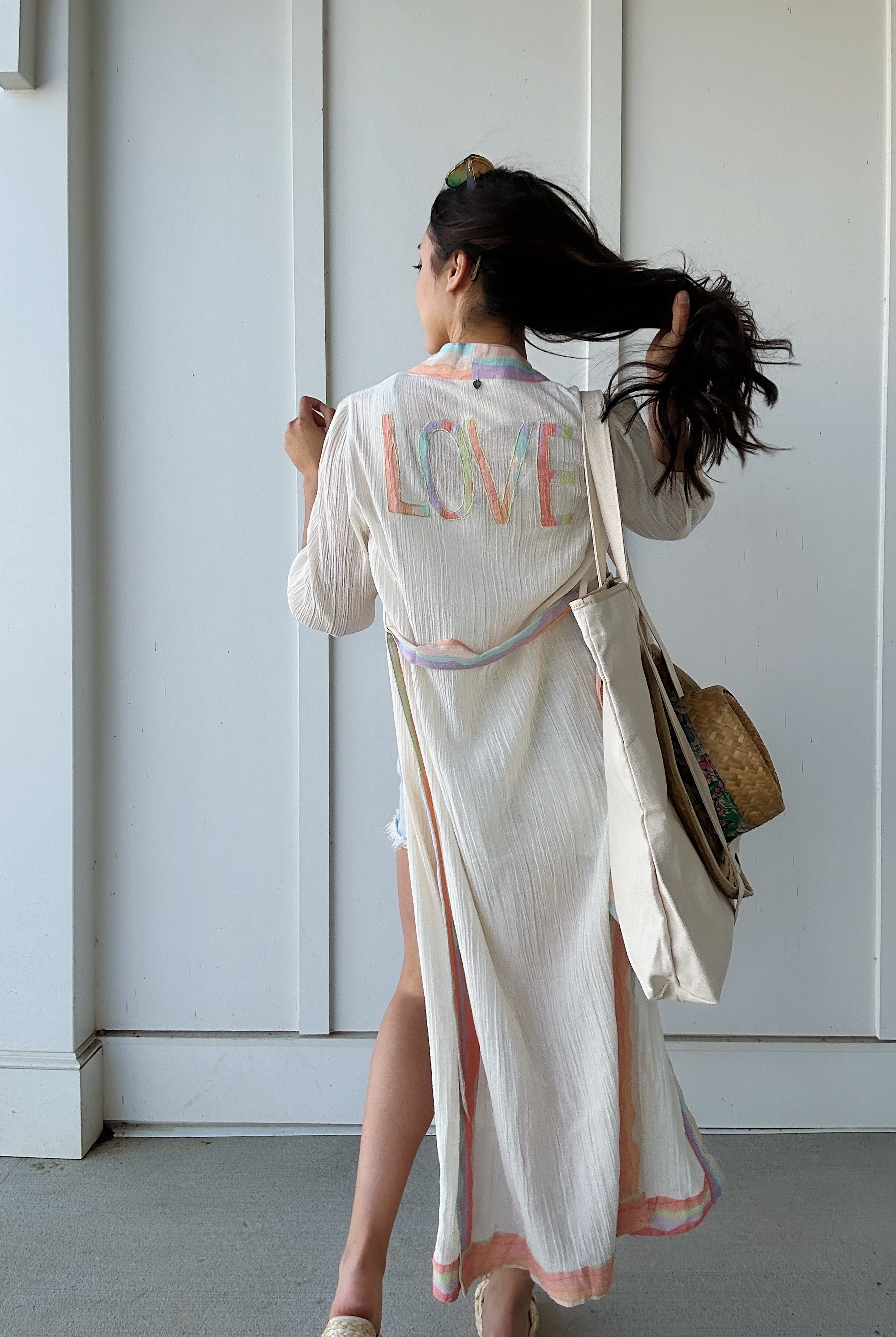 woman wearing duster that says LOVE on back