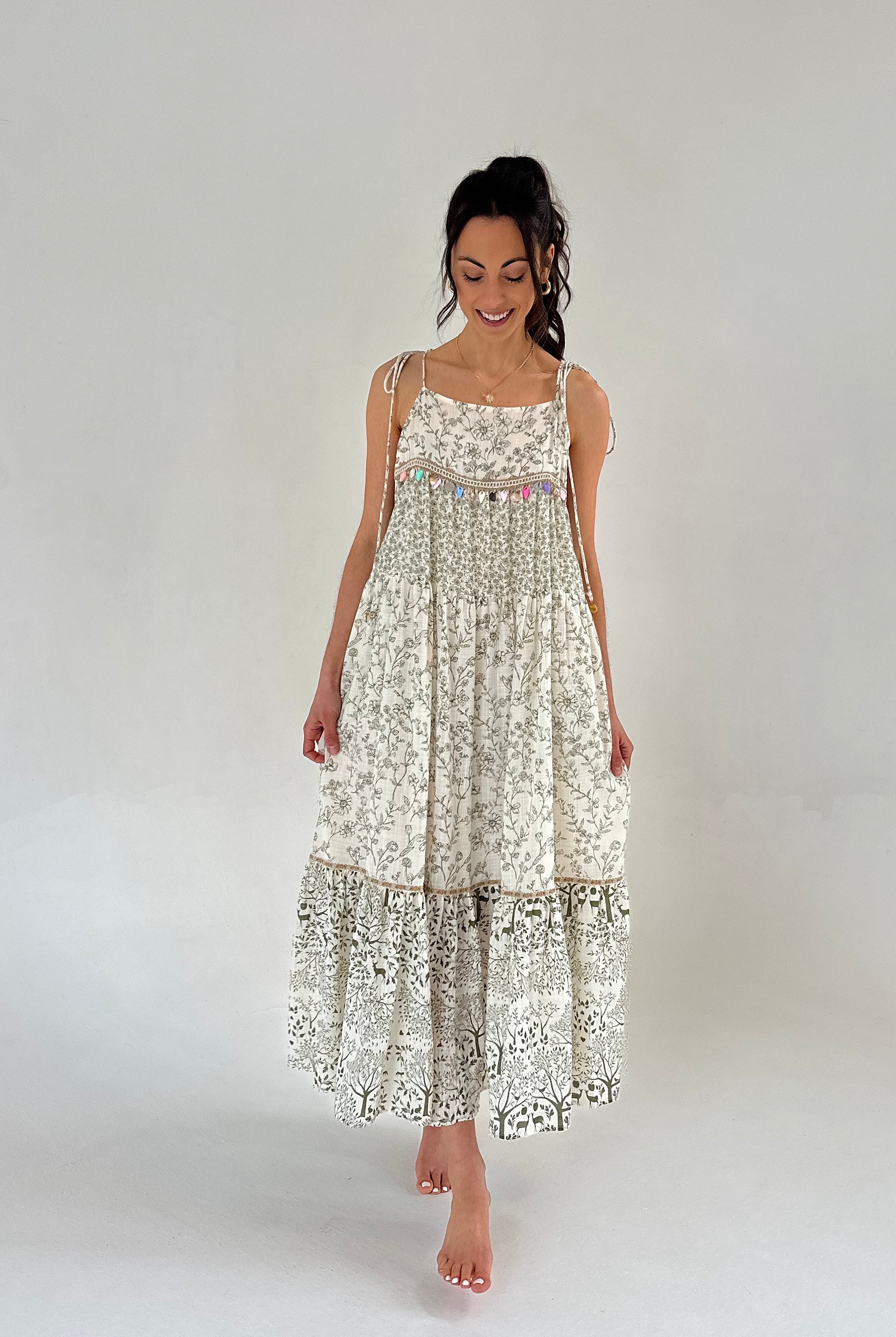 Woman wearing a floral dress on a plain background