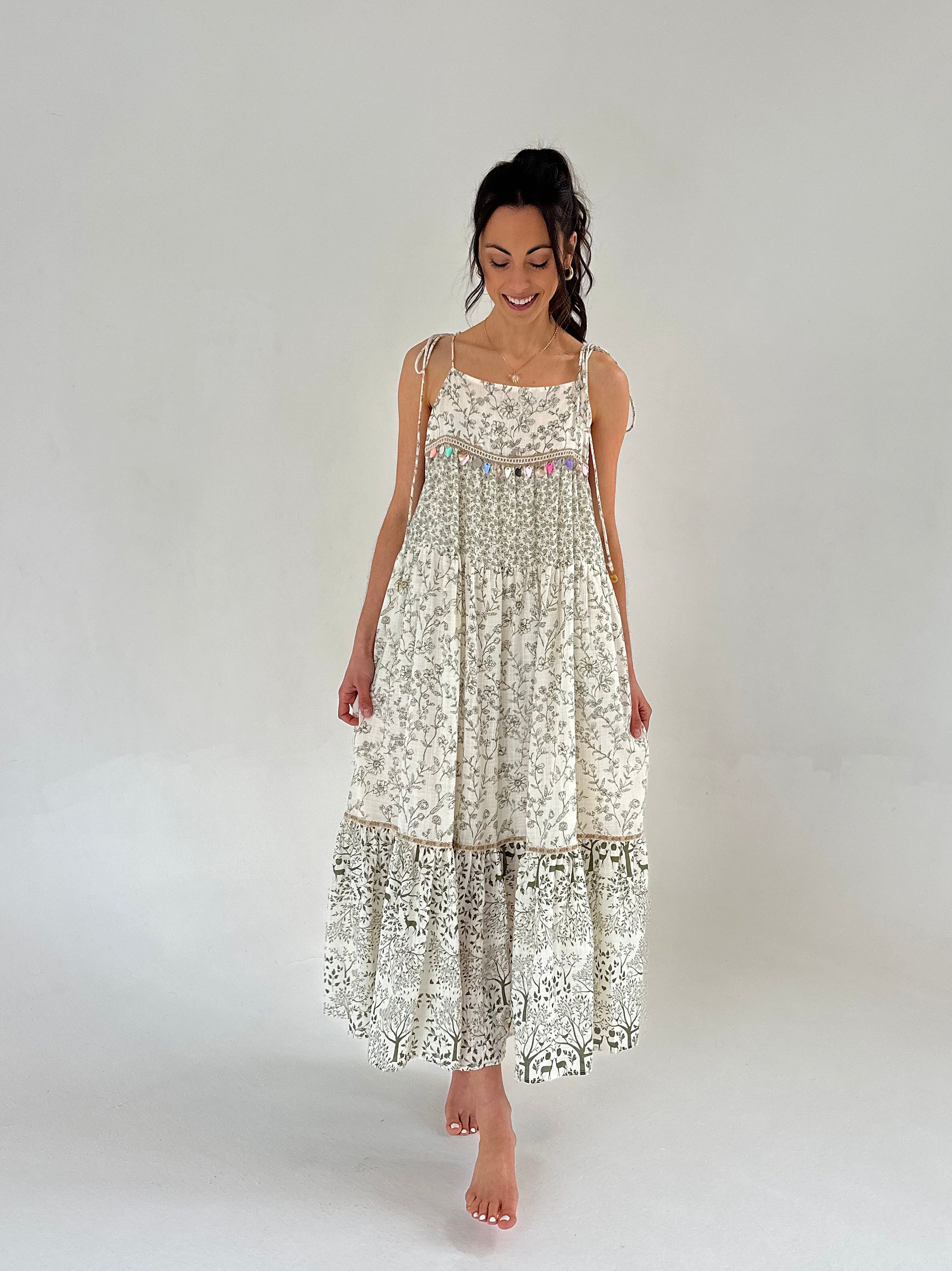 Woman wearing a floral dress on a plain background