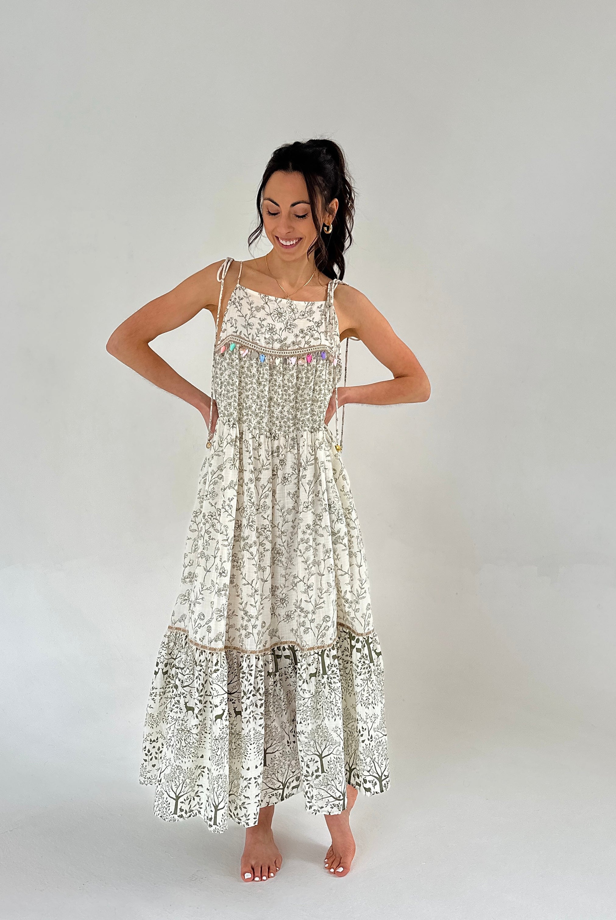 Woman wearing a floral dress on a plain background