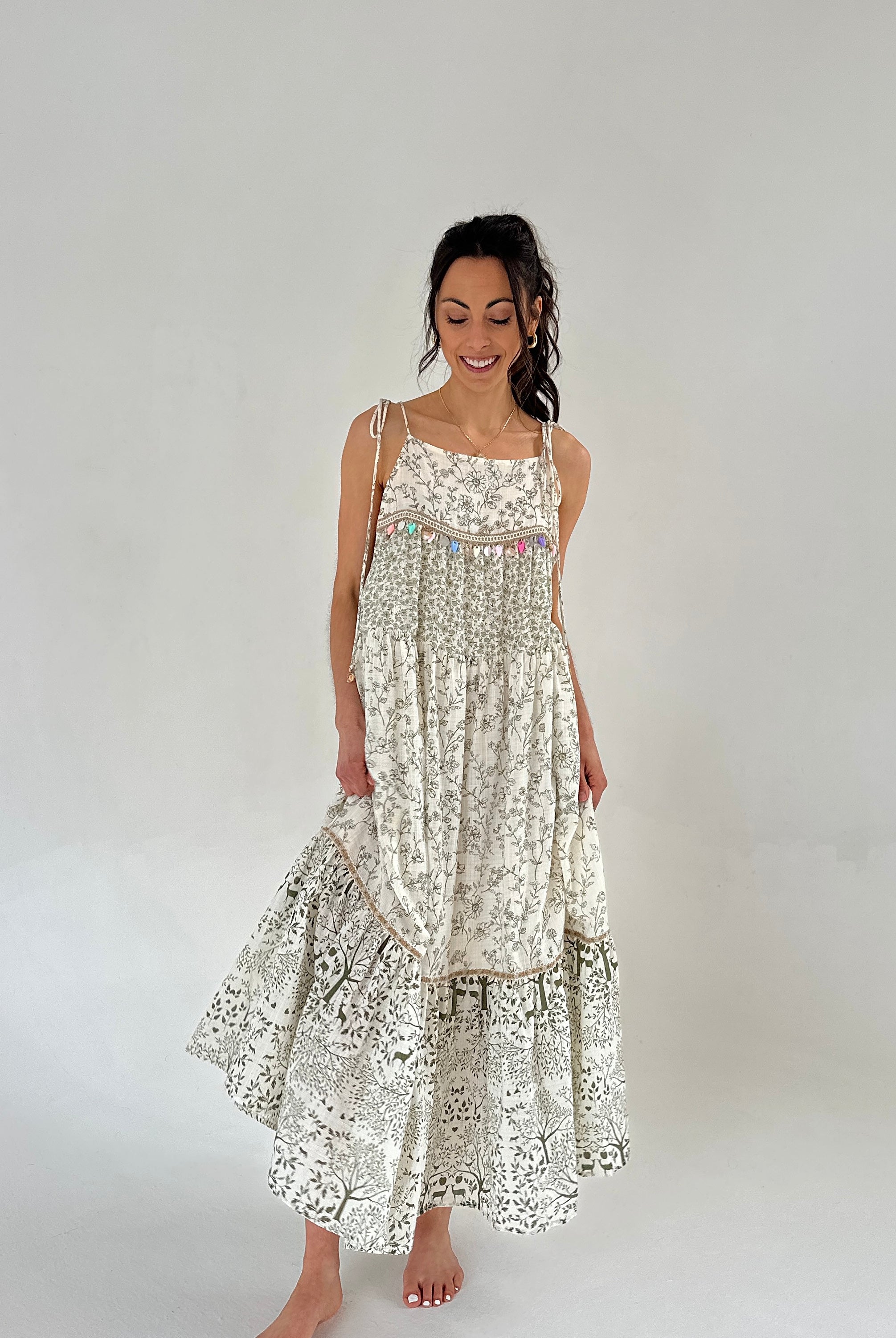 Woman wearing a floral dress on a plain background