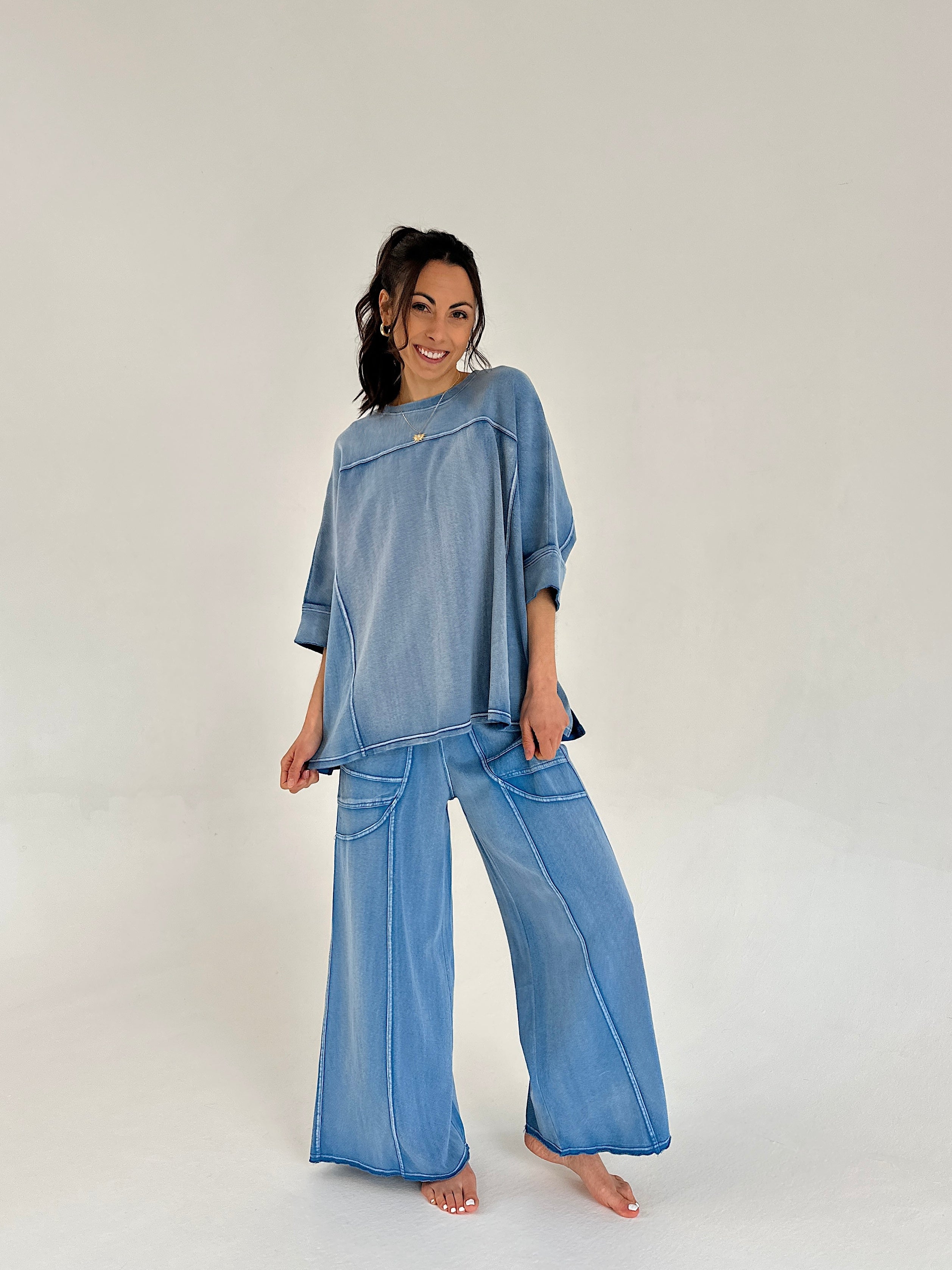 Woman wearing a blue matching outfit on a white background