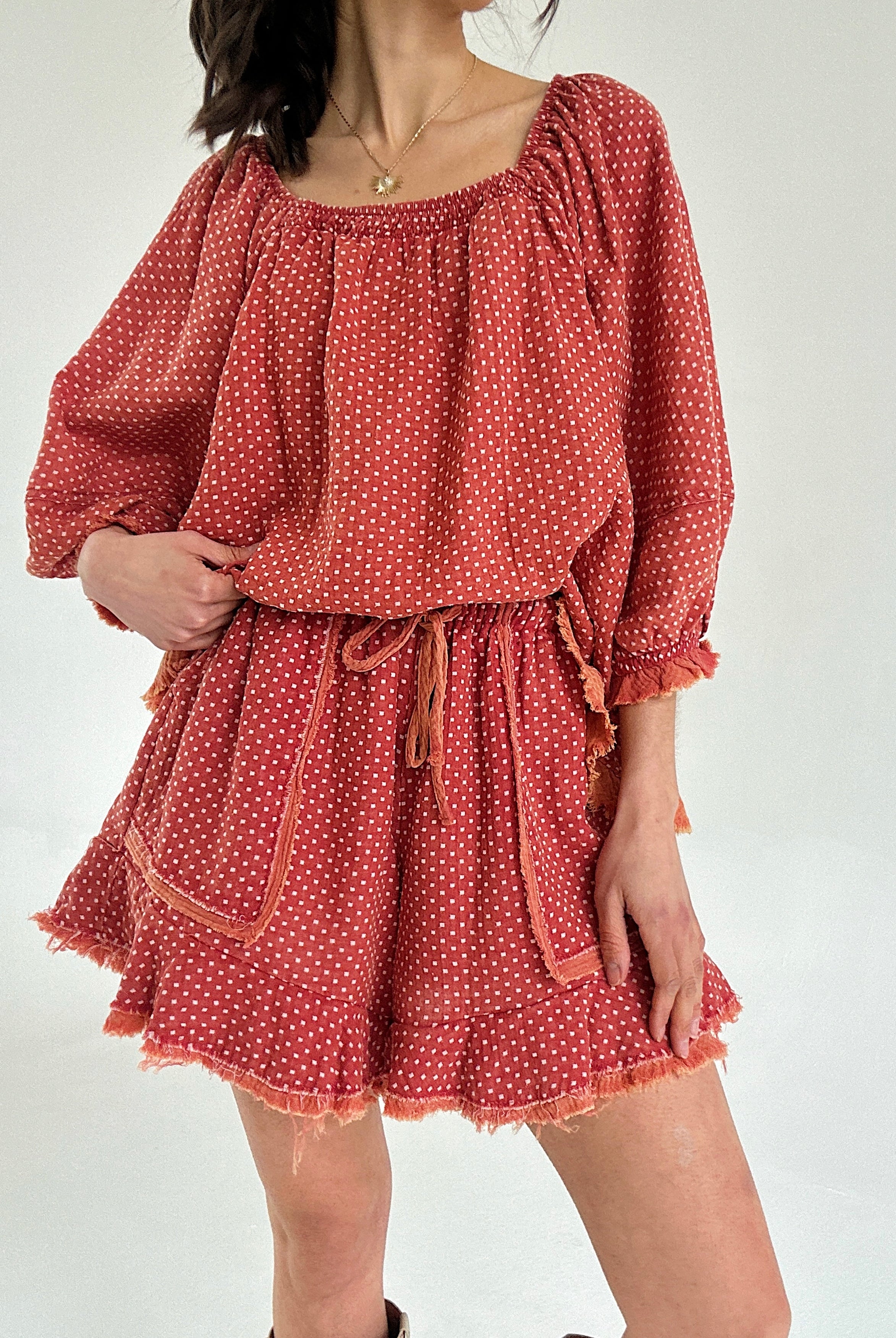 Red polka dot set with long sleeves and shorts on a white background