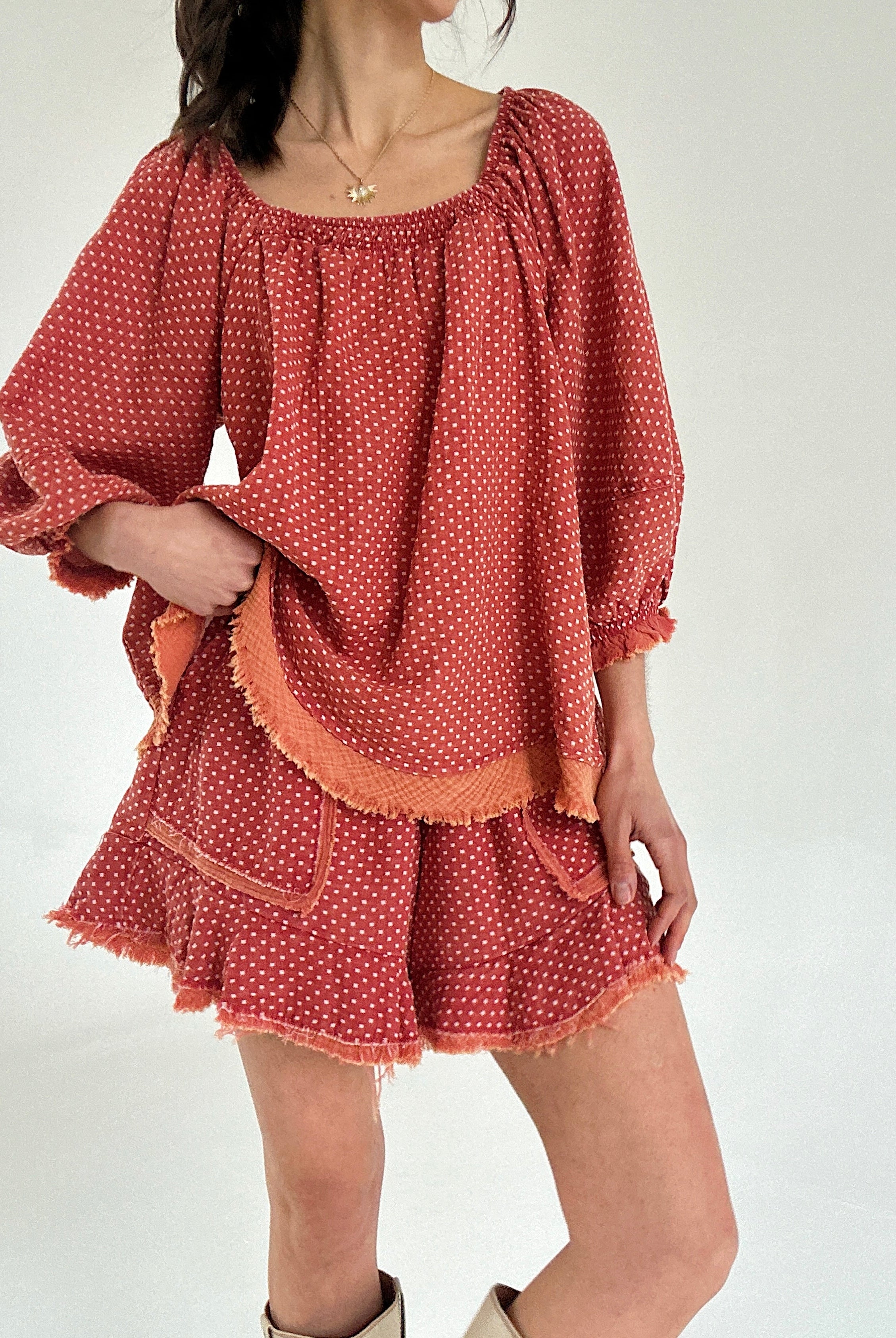 Red polka dot set with ruffled sleeves and hem on a white background