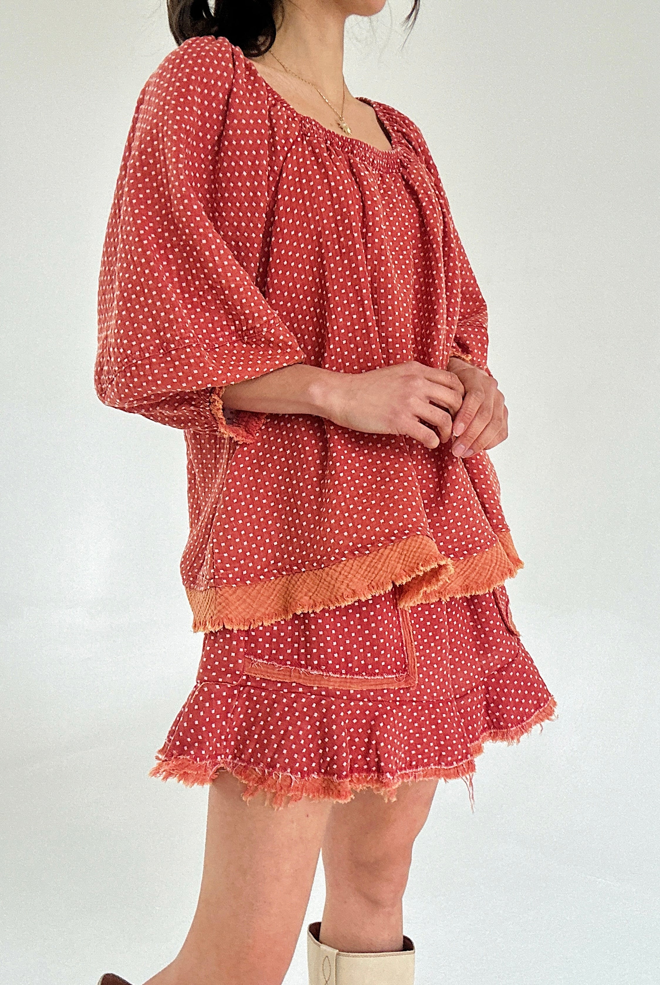 Red polka dot set with ruffled layers on a white background