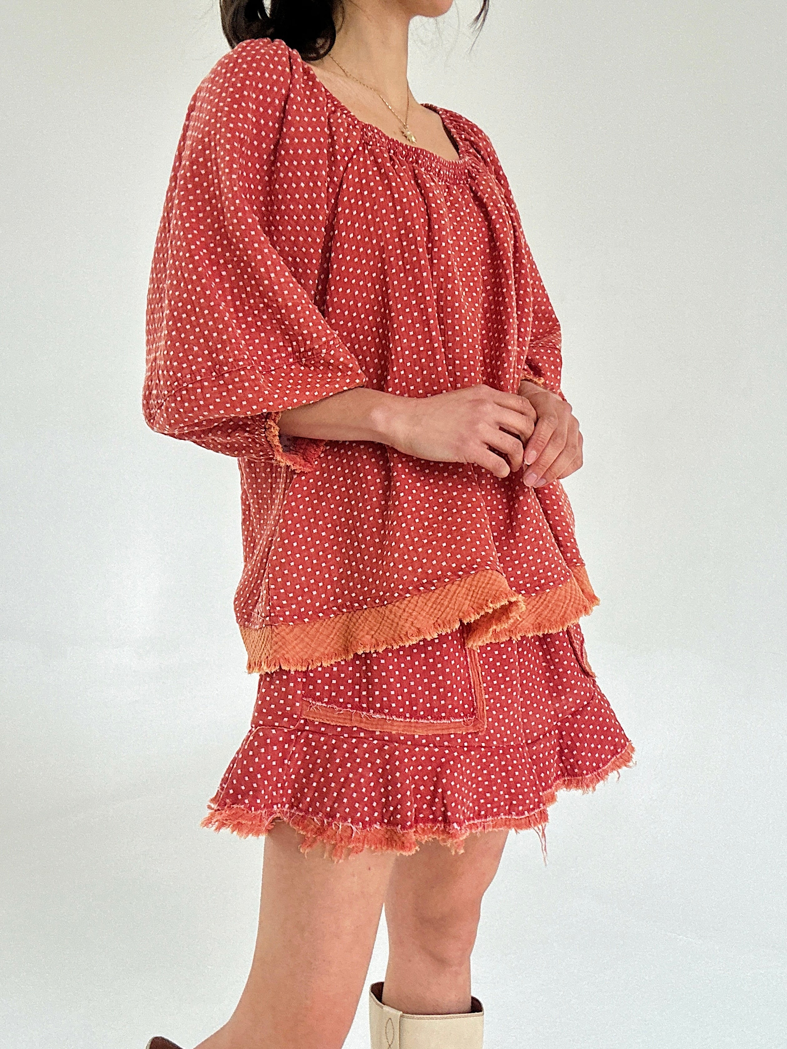 Red polka dot set with ruffled layers on a white background