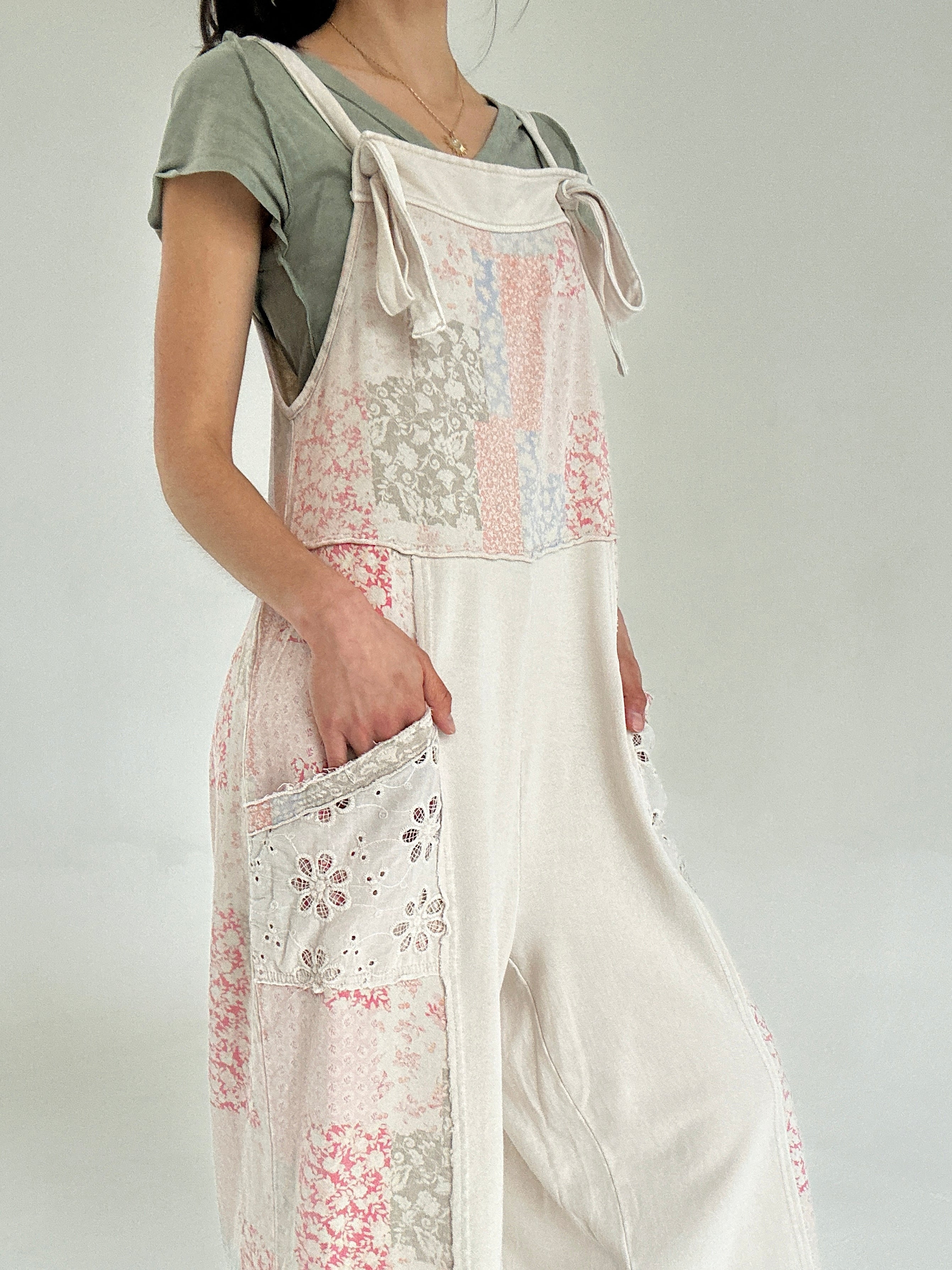 Person wearing a floral jumper over a plain shirt on a white background showing eyelet side pockets