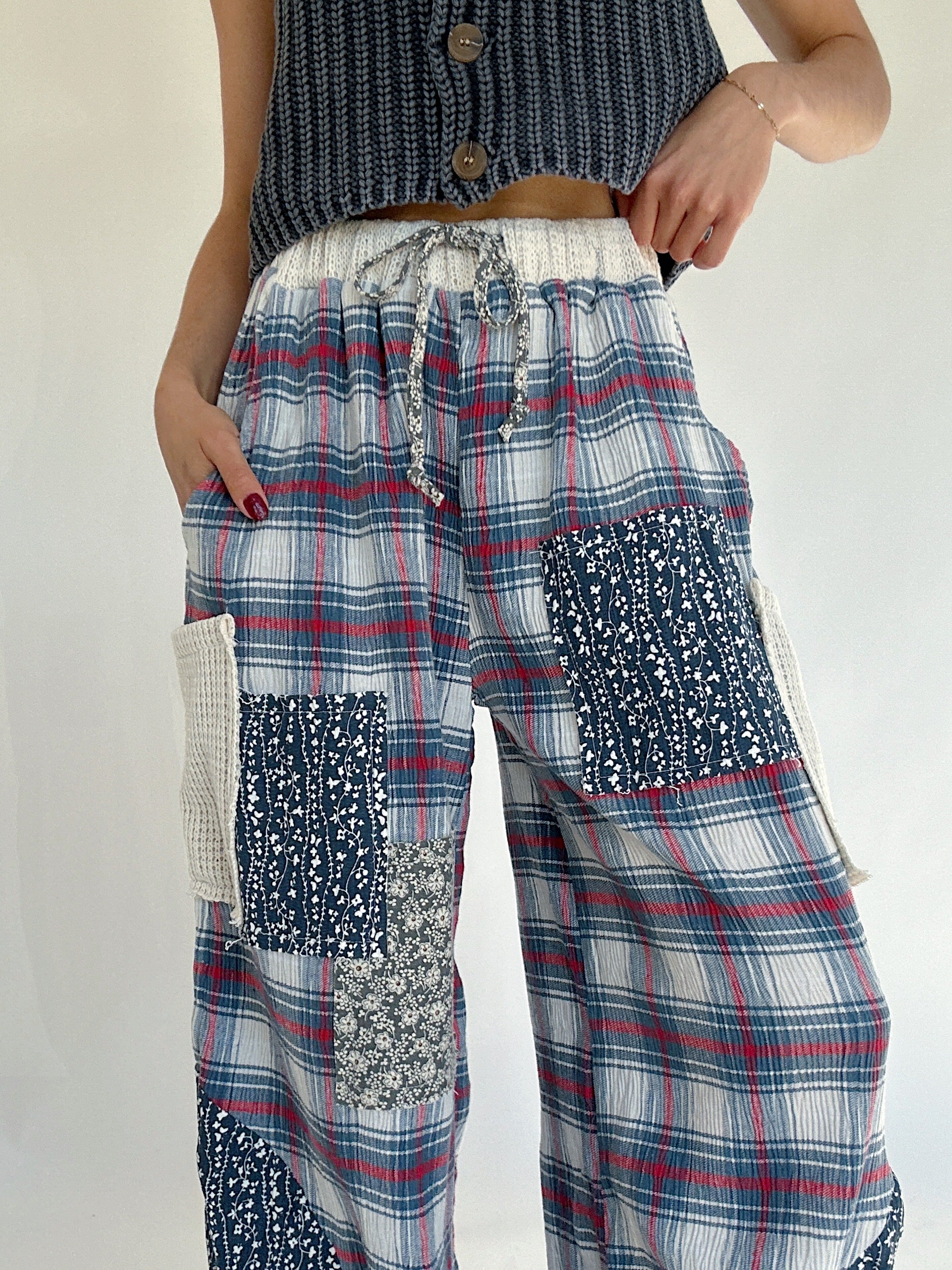 Person wearing plaid patchwork pants with a plain background - elastic drawstring waist