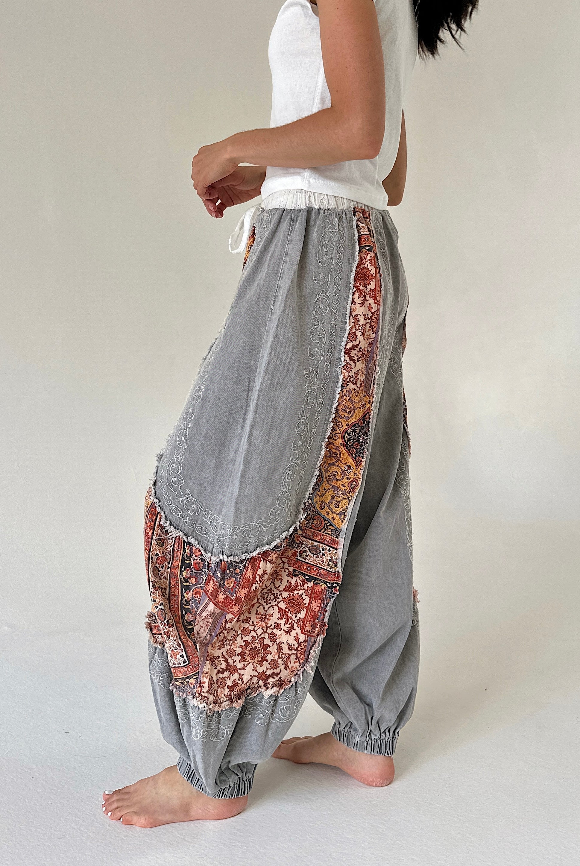 woman wearing charcoal jogger pants with floral accents