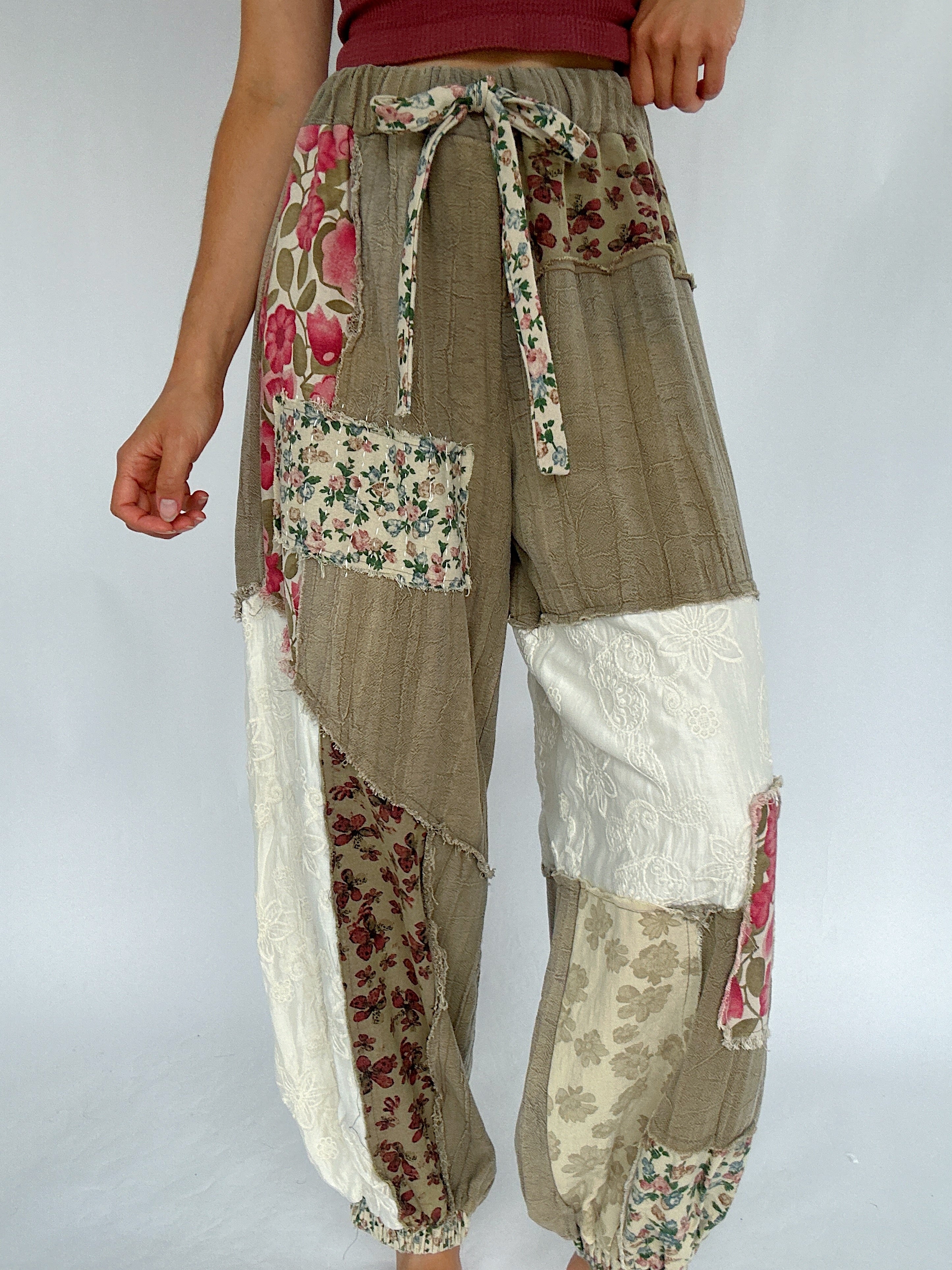 Patchwork pants with floral patterns on a plain background