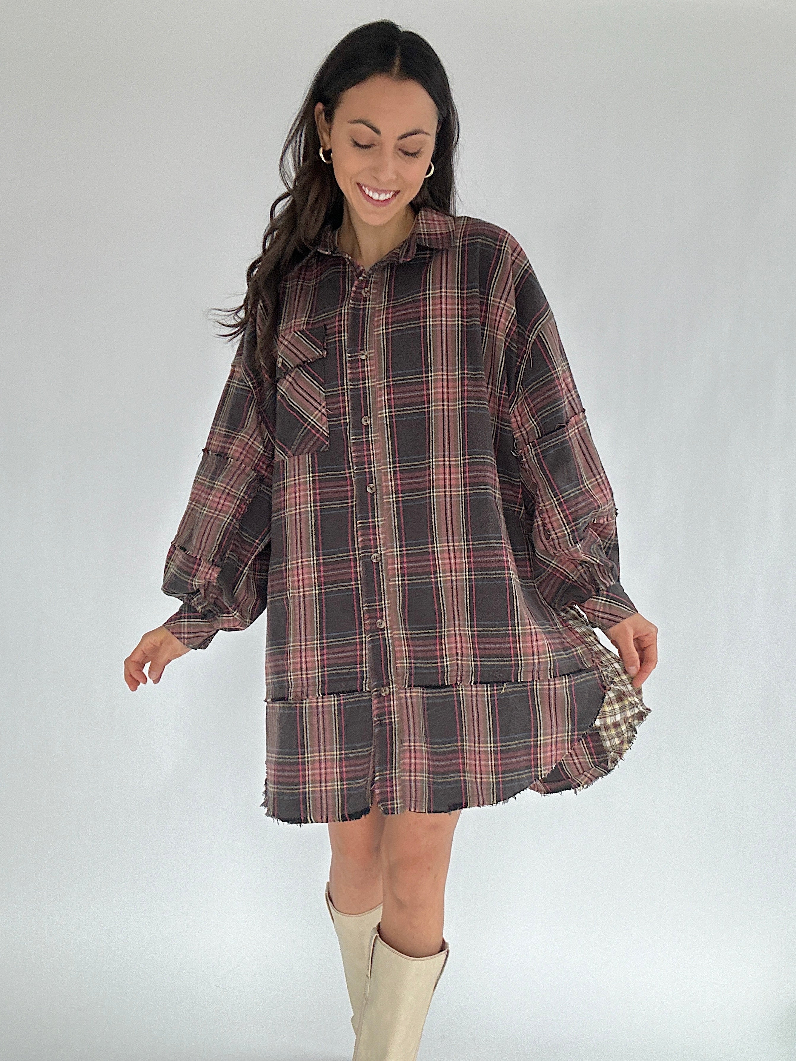 Woman wearing a plaid dress with a plain background