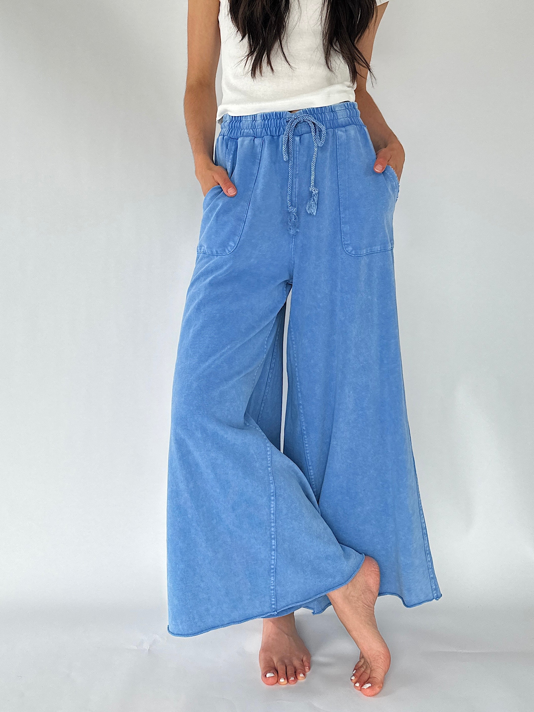 wide leg terry knit pants with drawstring modeled by woman in a studio setting