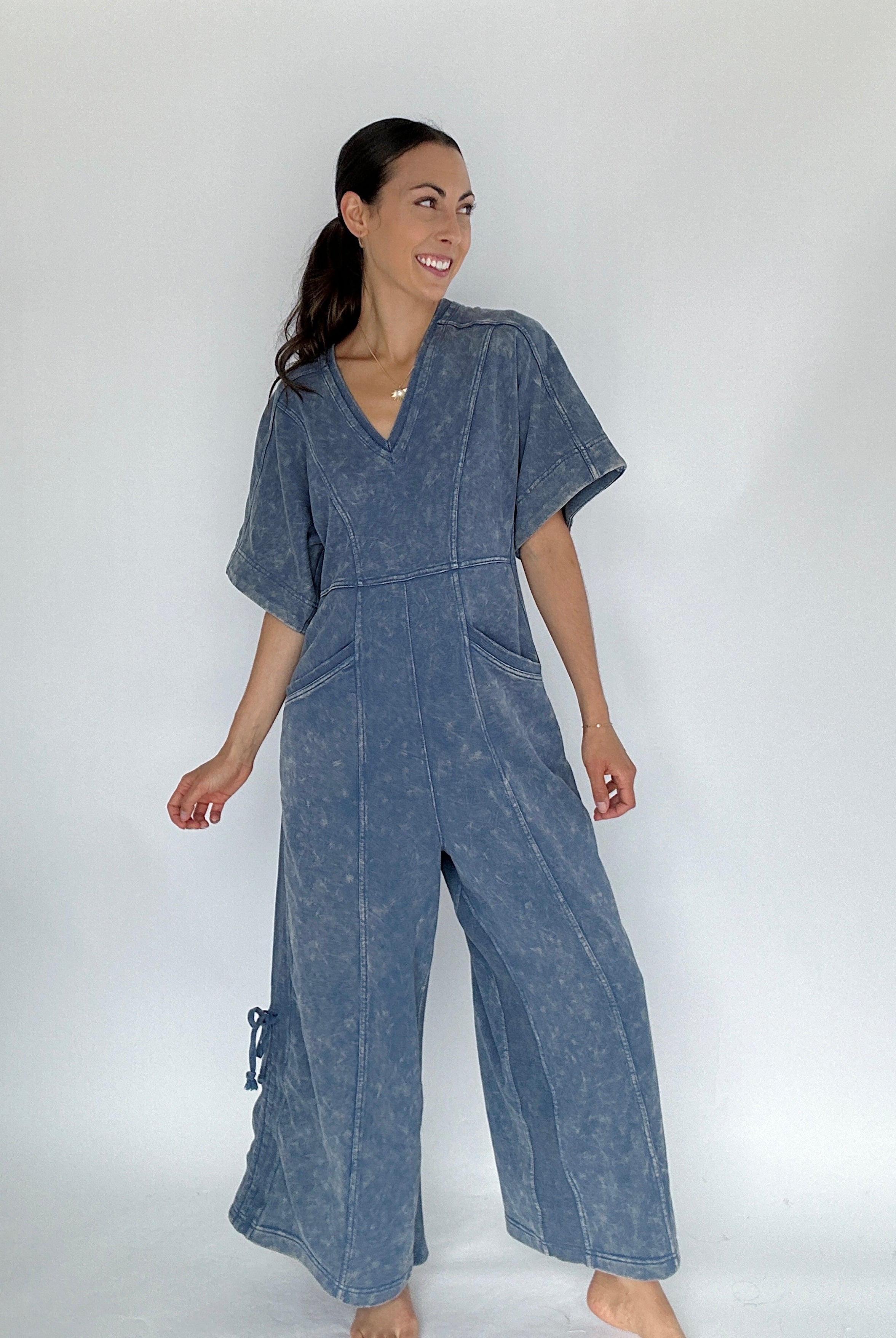 Woman wearing a blue jumpsuit on a white background