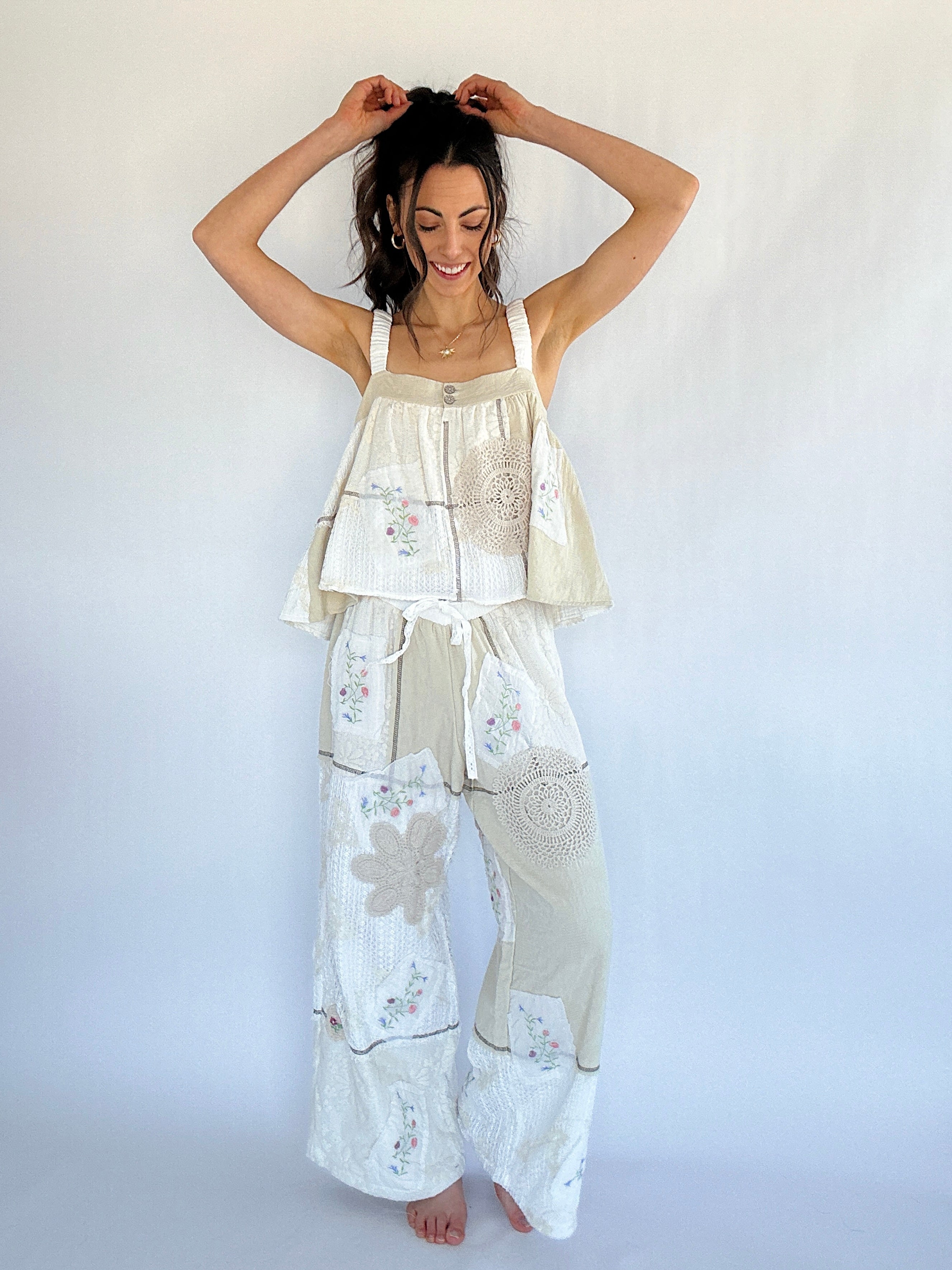 Woman wearing a beige and white floral pajama set against a plain background