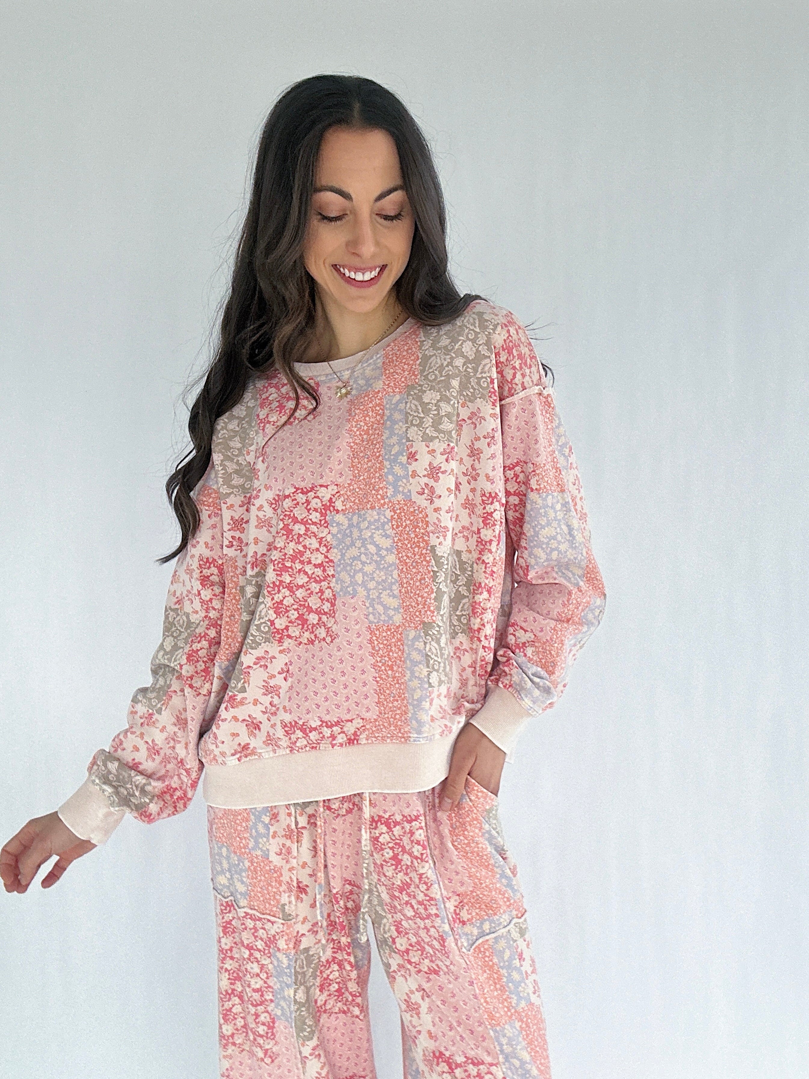 Woman wearing a floral patchwork outfit on a white background
