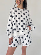 Person wearing a polka dot outfit with a white background