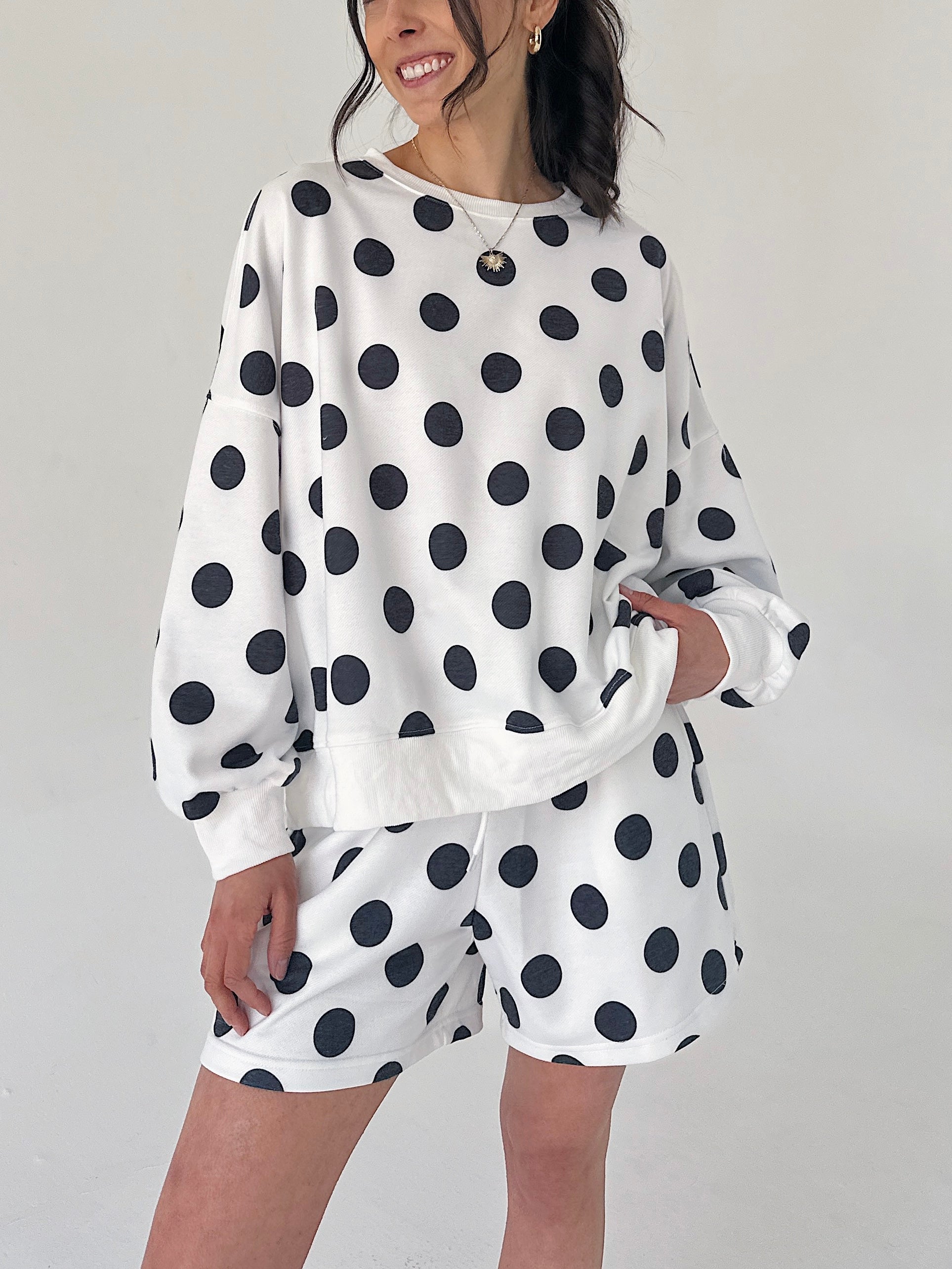 Person wearing a polka dot outfit with a white background