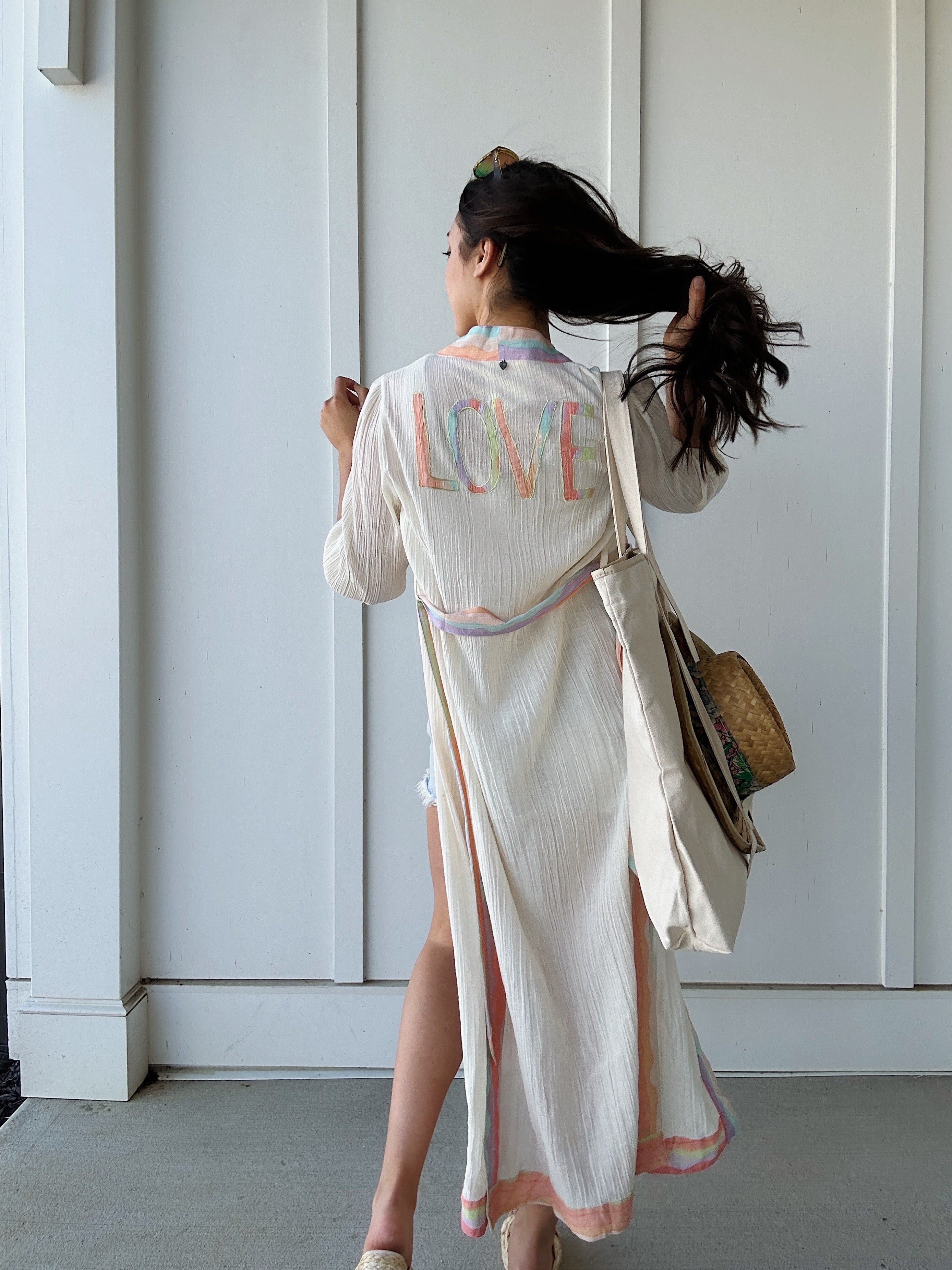 woman wearing duster that says LOVE on back