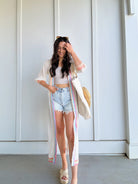 woman wearing denim shorts with duster