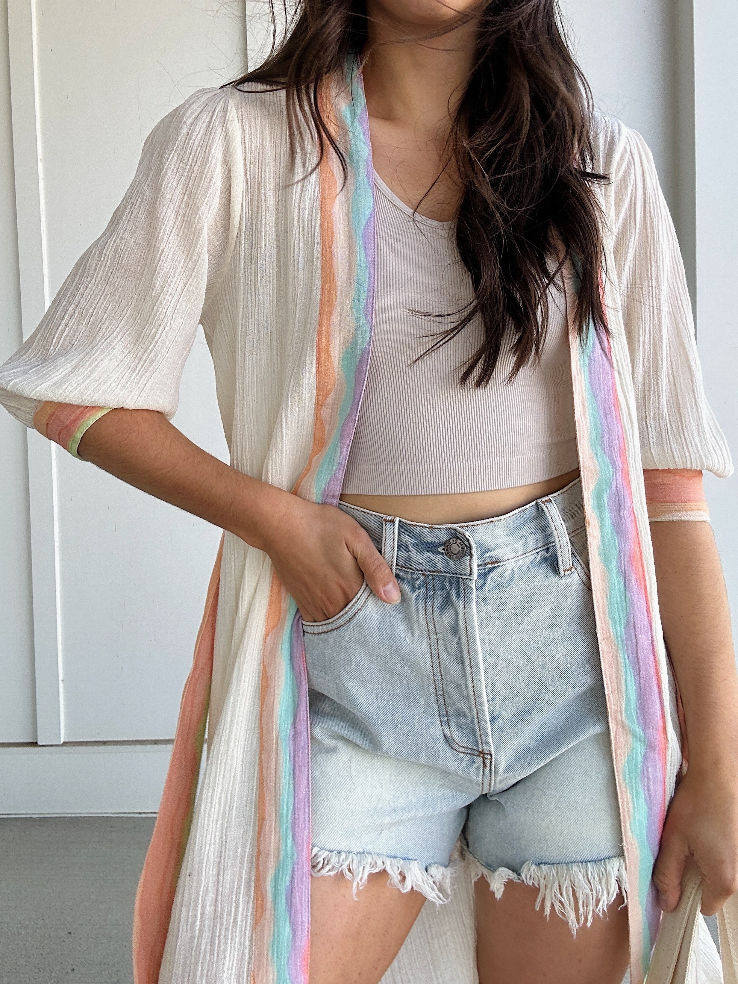 woman wearing duster with colorful stripes