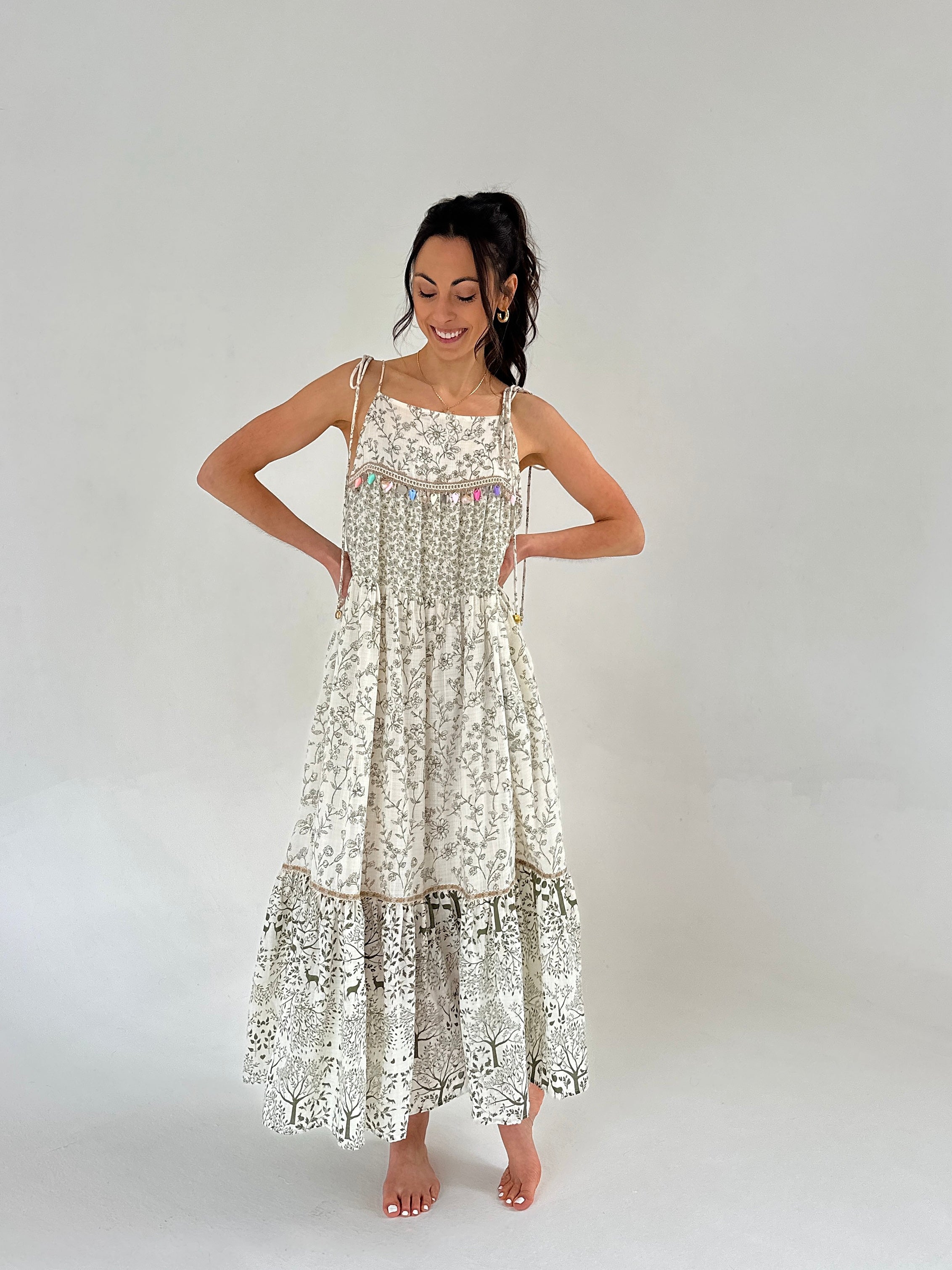 Woman wearing a floral dress on a plain background