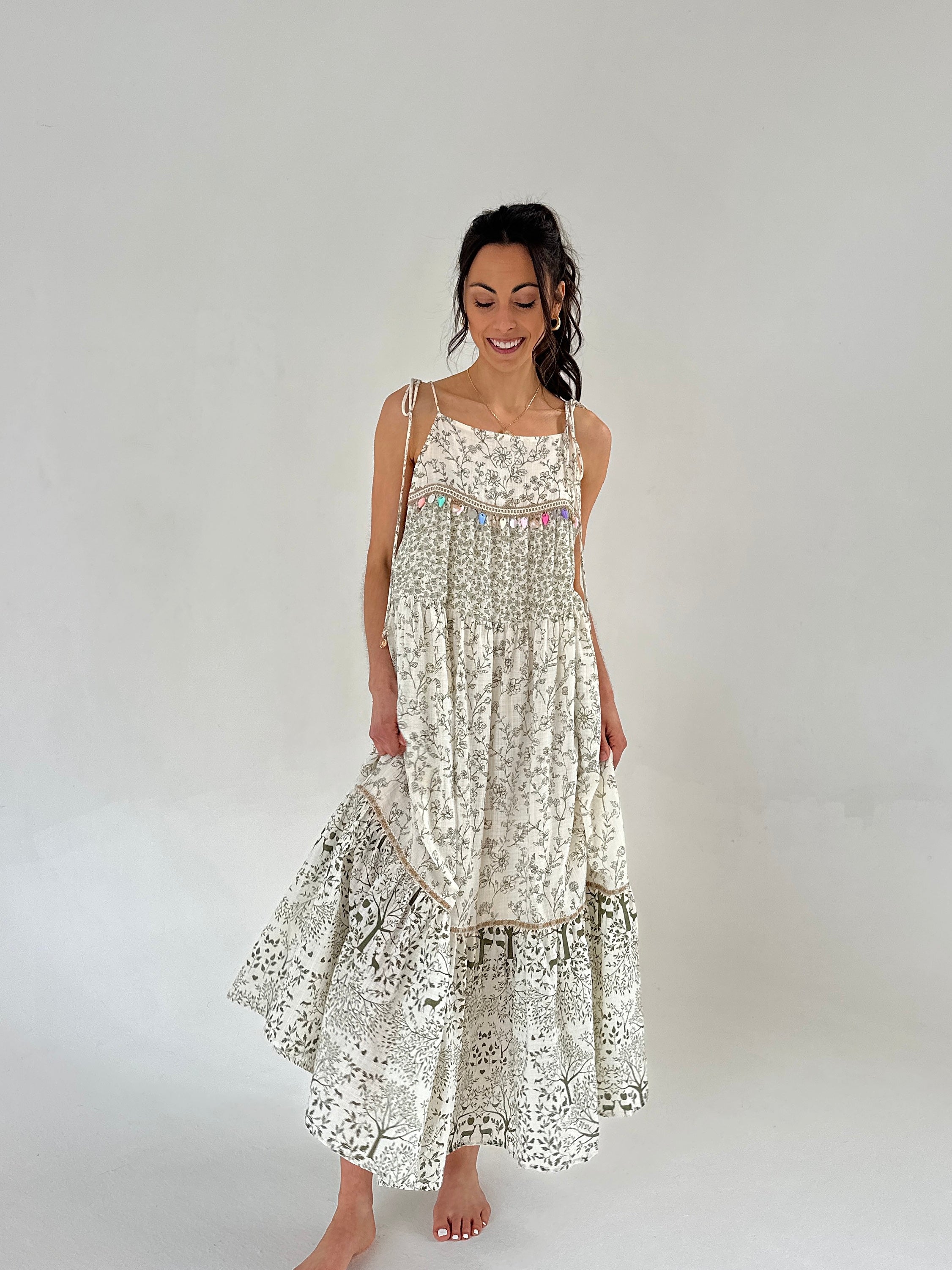 Woman wearing a floral dress on a plain background