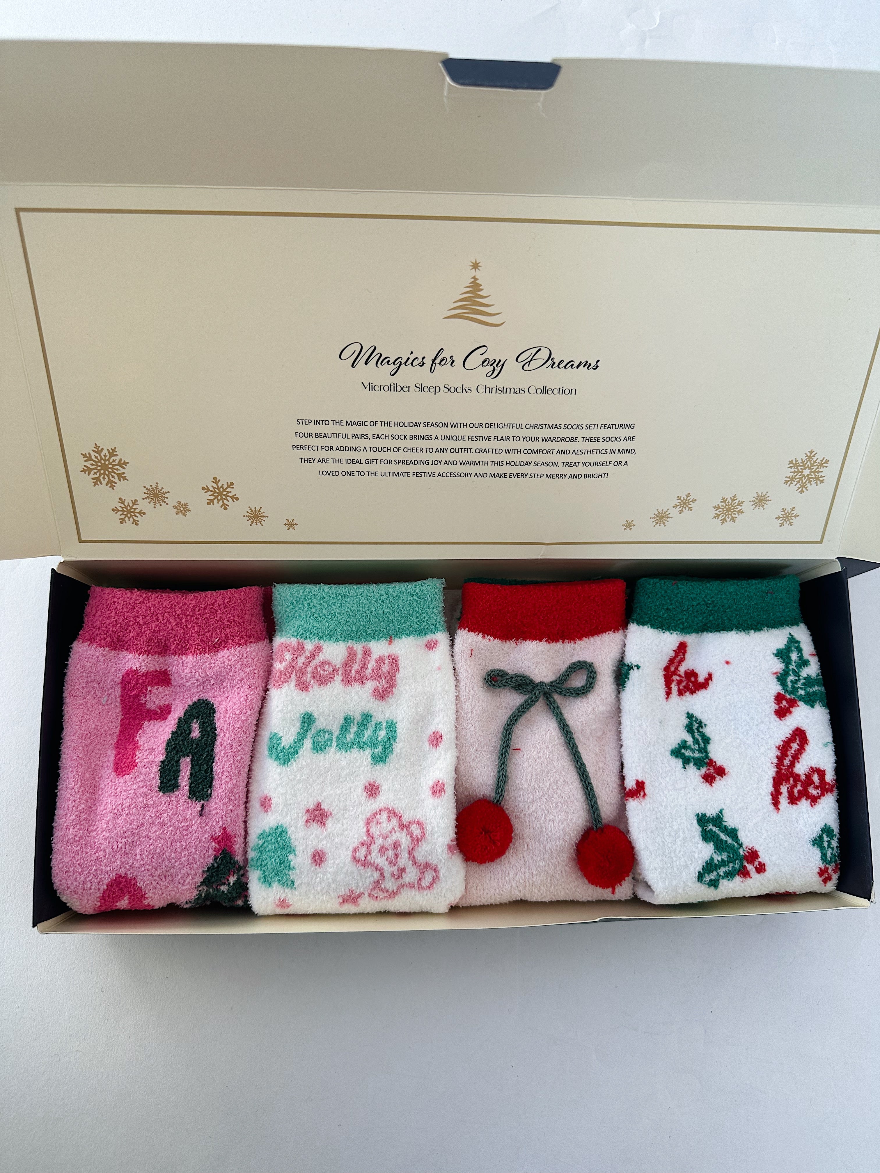 Set of four Christmas-themed socks in a decorative box