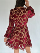 Red lace dress on a white background showing back zipper