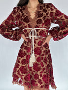 Red and brown floral lace dress with long sleeves on a white background