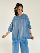 Woman wearing a blue outfit on a plain background