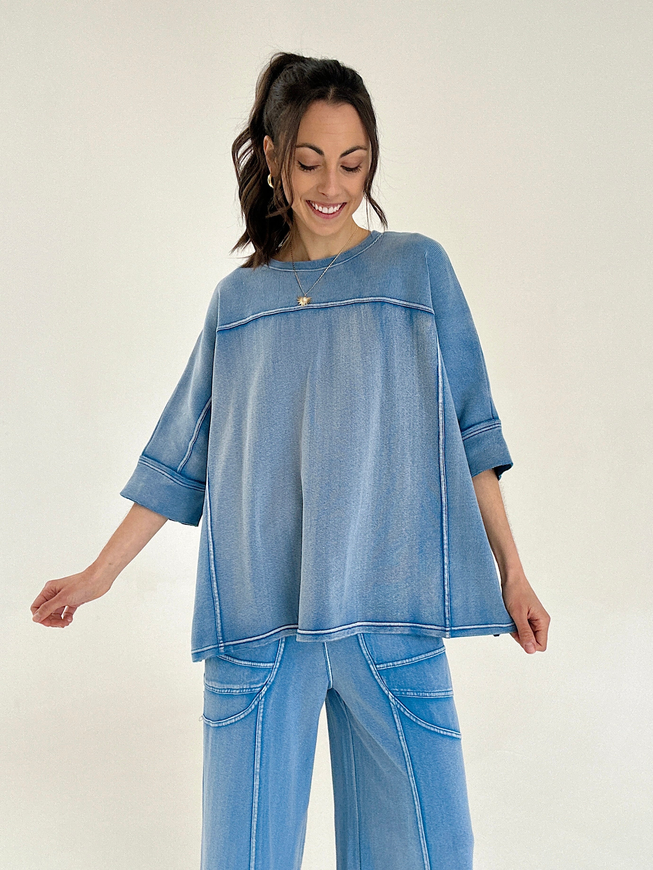 Woman wearing a blue outfit on a plain background