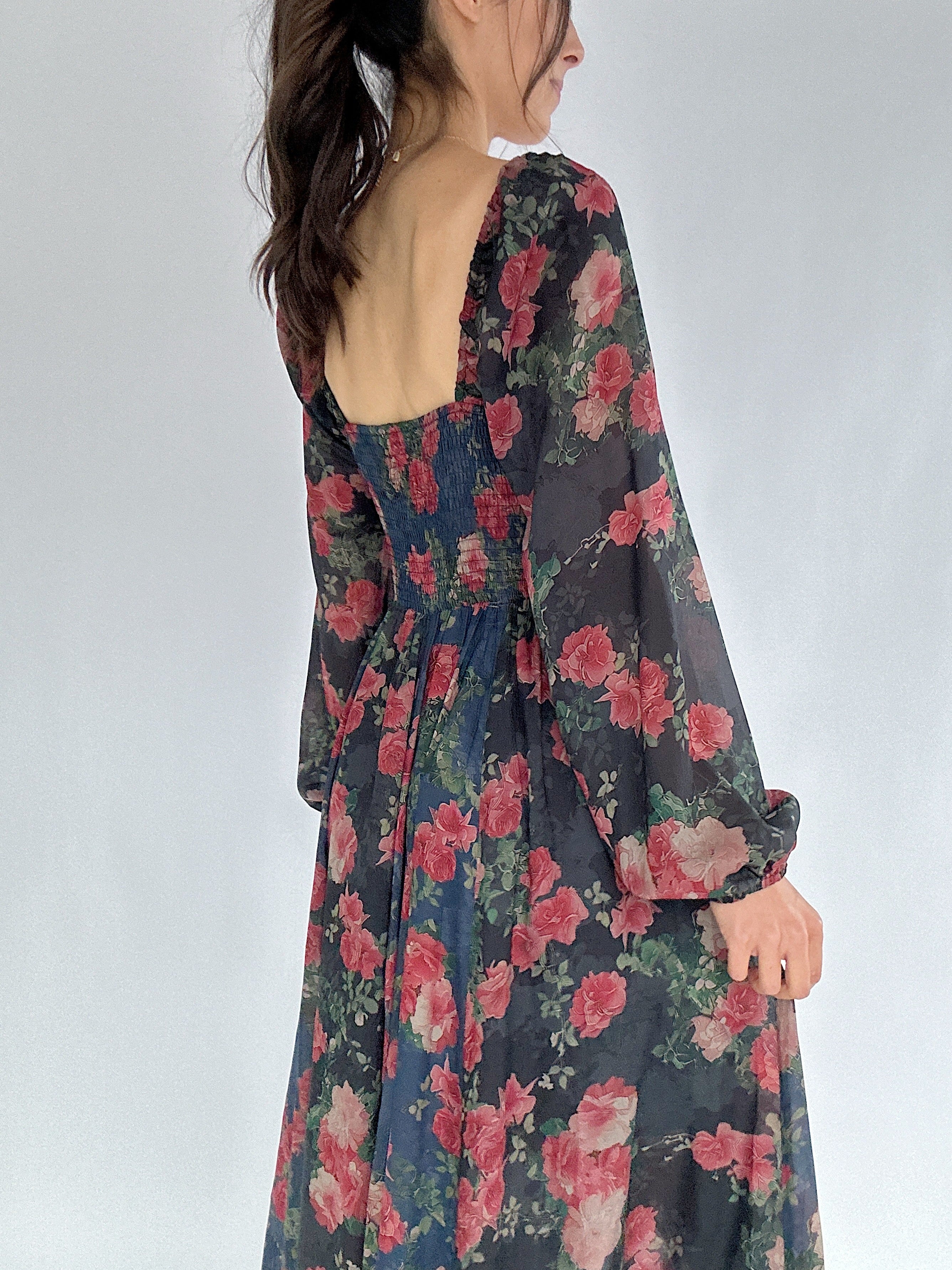 Floral dress with long sleeves on a plain background showing smocked back