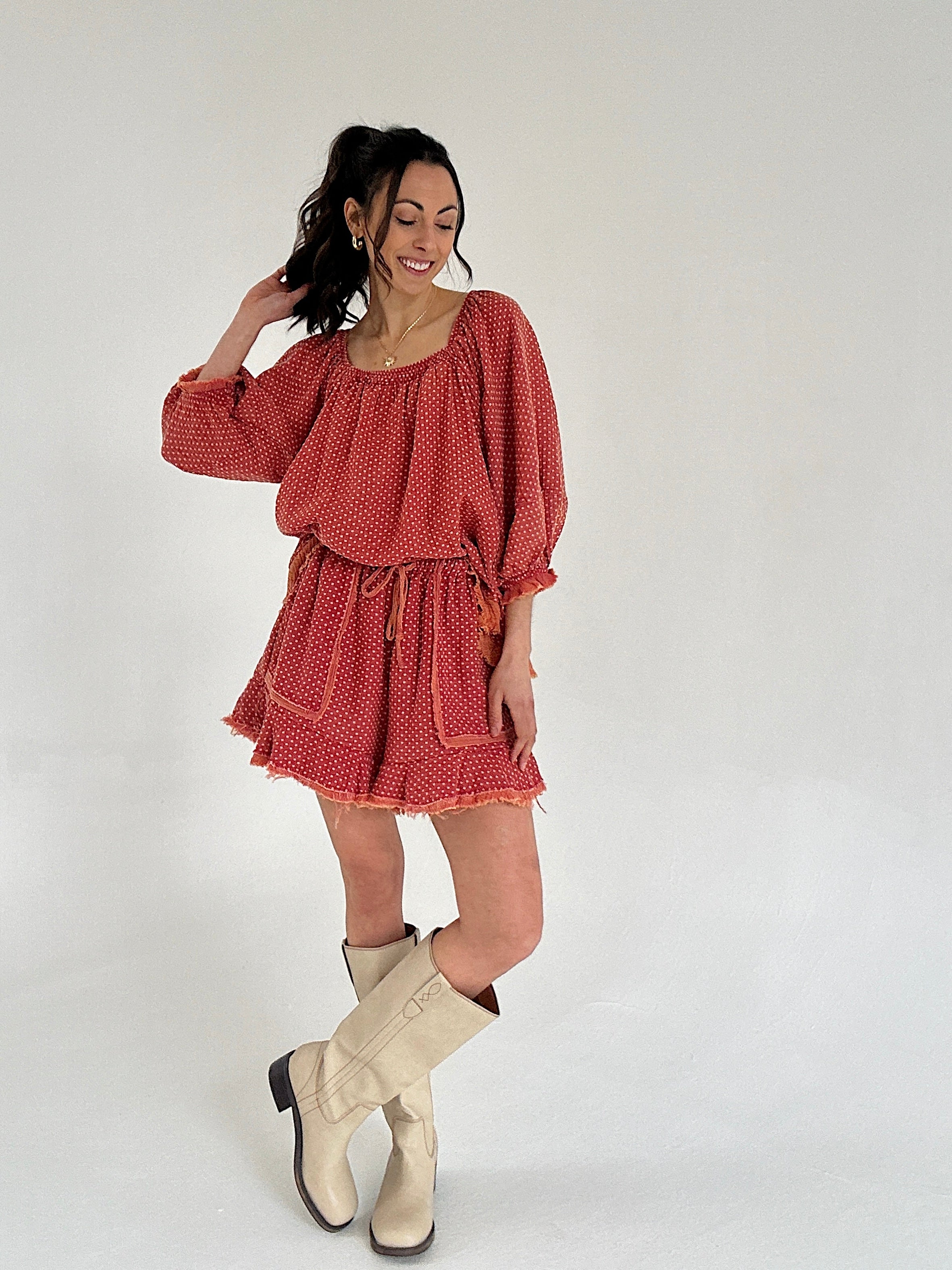 Woman wearing a red set with long sleeves and a white background