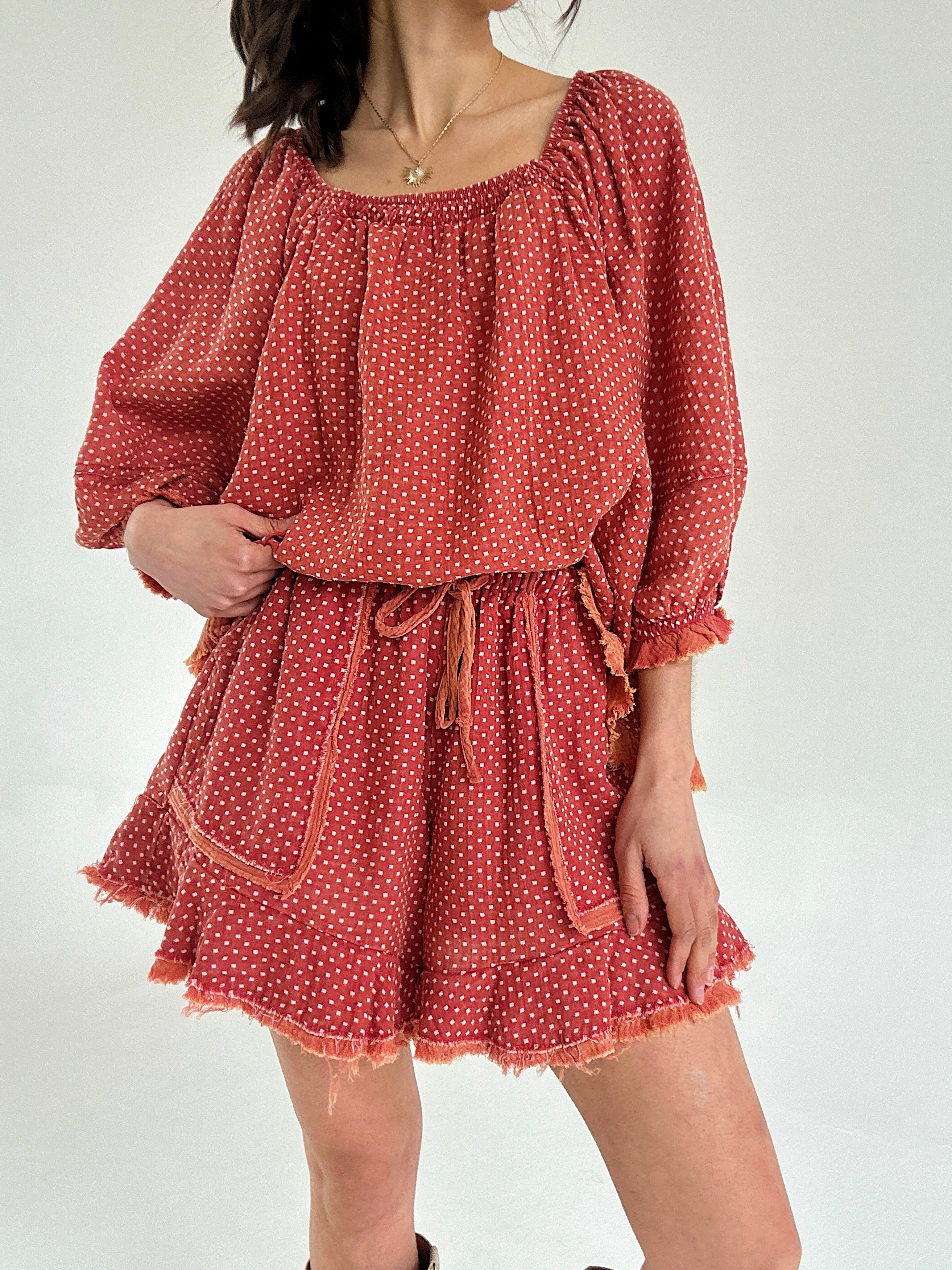 Red polka dot set with long sleeves and shorts on a white background