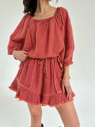 Red polka dot set with long sleeves and shorts on a white background
