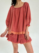 Red polka dot set with long sleeves and shorts on a white background