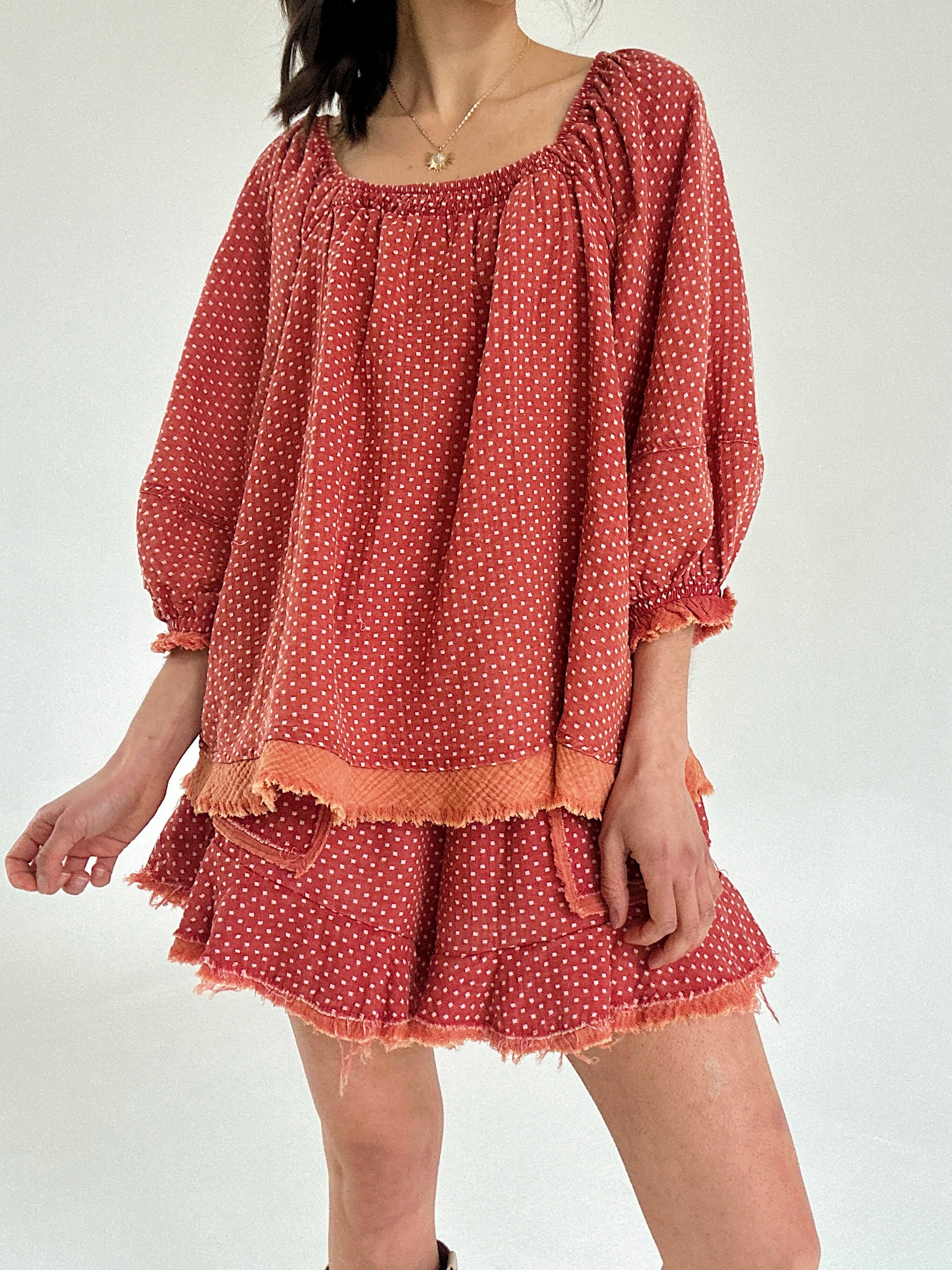 Red polka dot set with long sleeves and shorts on a white background