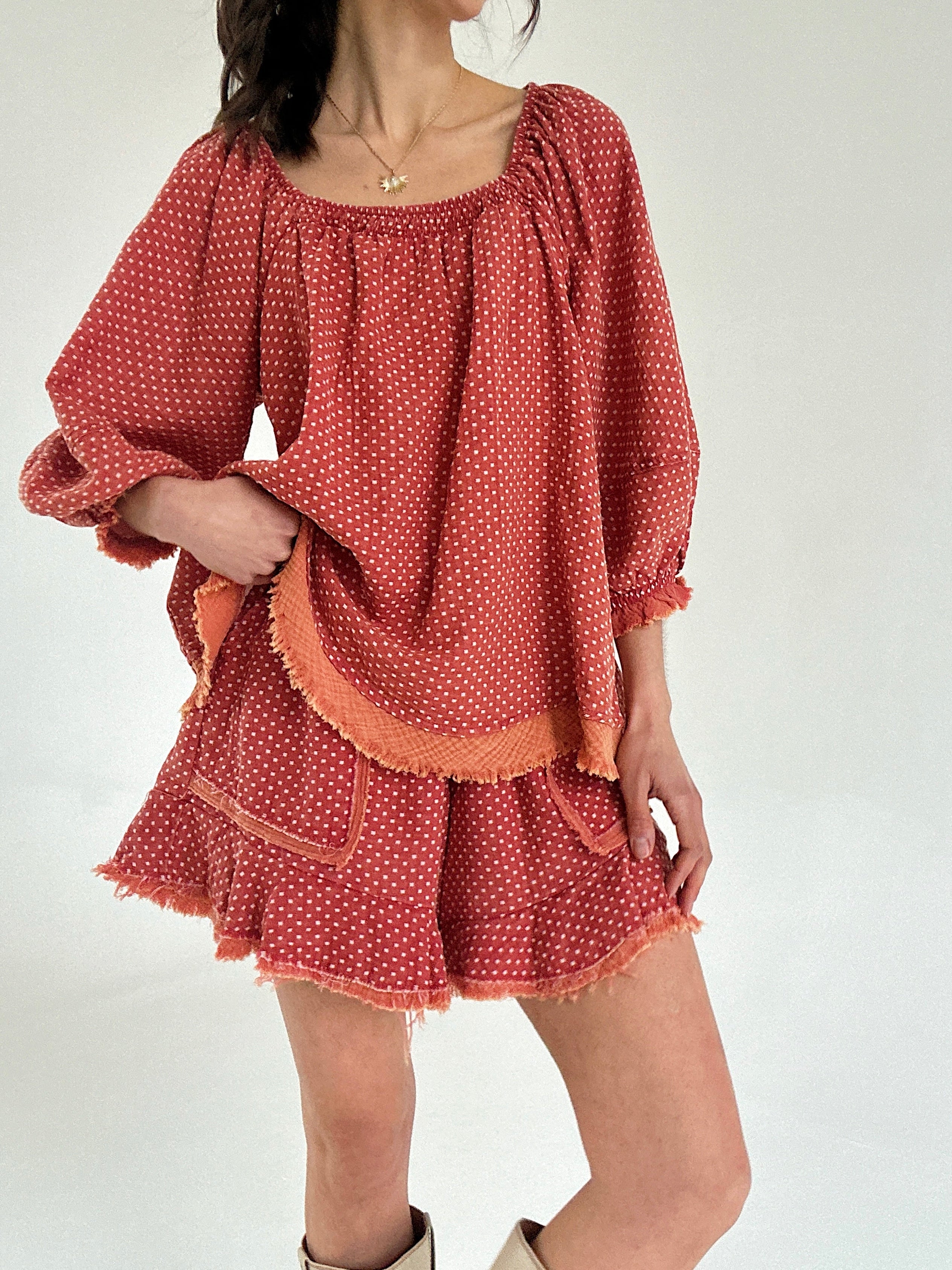 Red polka dot set with ruffled sleeves and hem on a white background