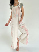 Person wearing a floral patchwork printed jumper over a plain green tee on a white background