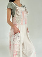 Person wearing a floral jumper over a plain shirt on a white background showing eyelet side pockets