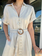 Oatmeal linen dress v-neckline with collar, front buttons, waist belt and side pockets.