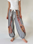 Grey joggers with floral accents and white drawstring