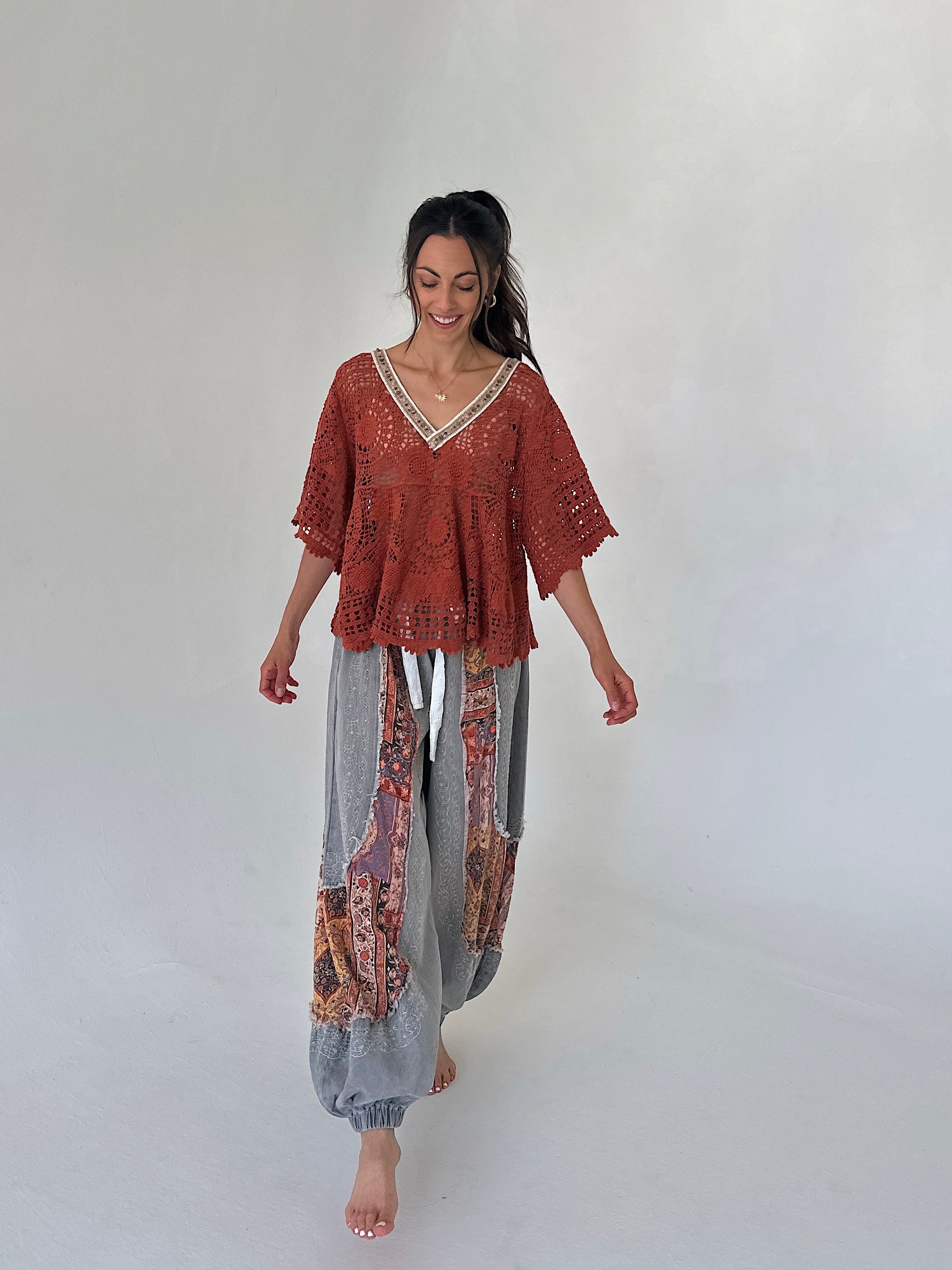 woman wearing a rust top with charcoal jogger pants
