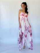 Woman wearing a floral strapless dress against a white background