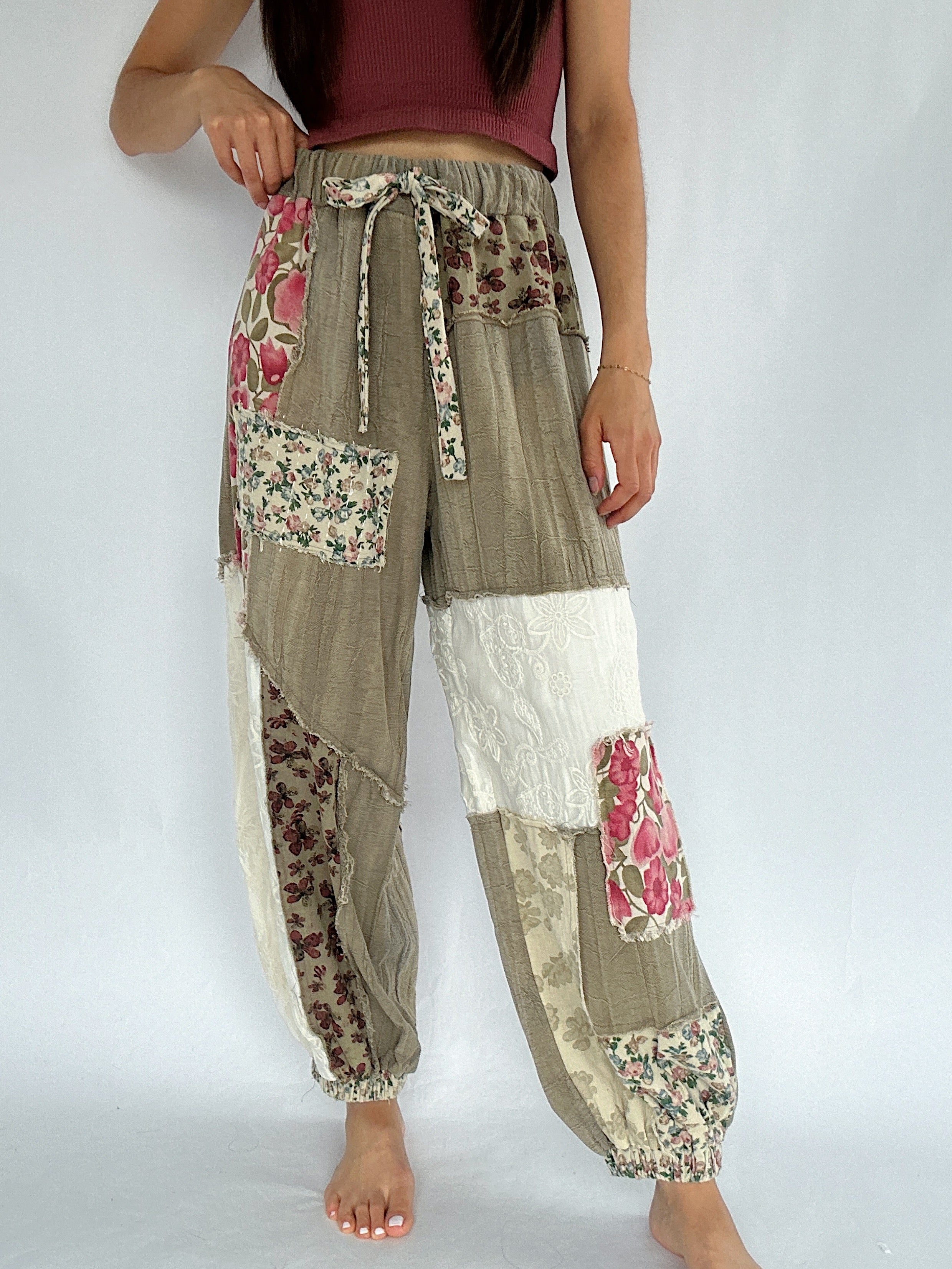 Patchwork pants with floral patterns on a white background