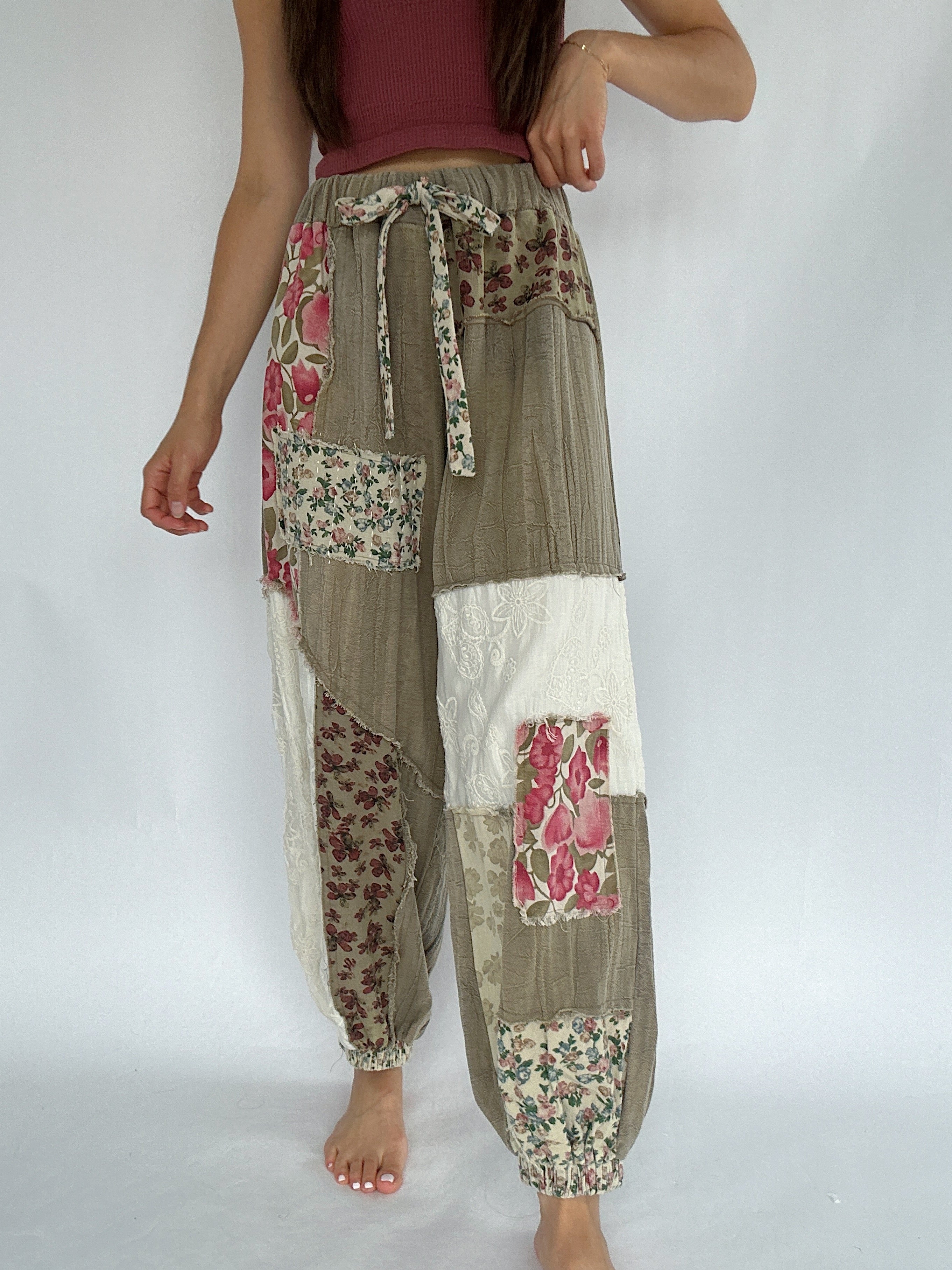 Patchwork pants with floral patterns on a plain background