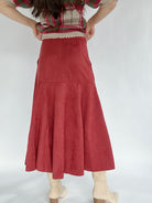 Red suede skirt worn by a person on a white background back view