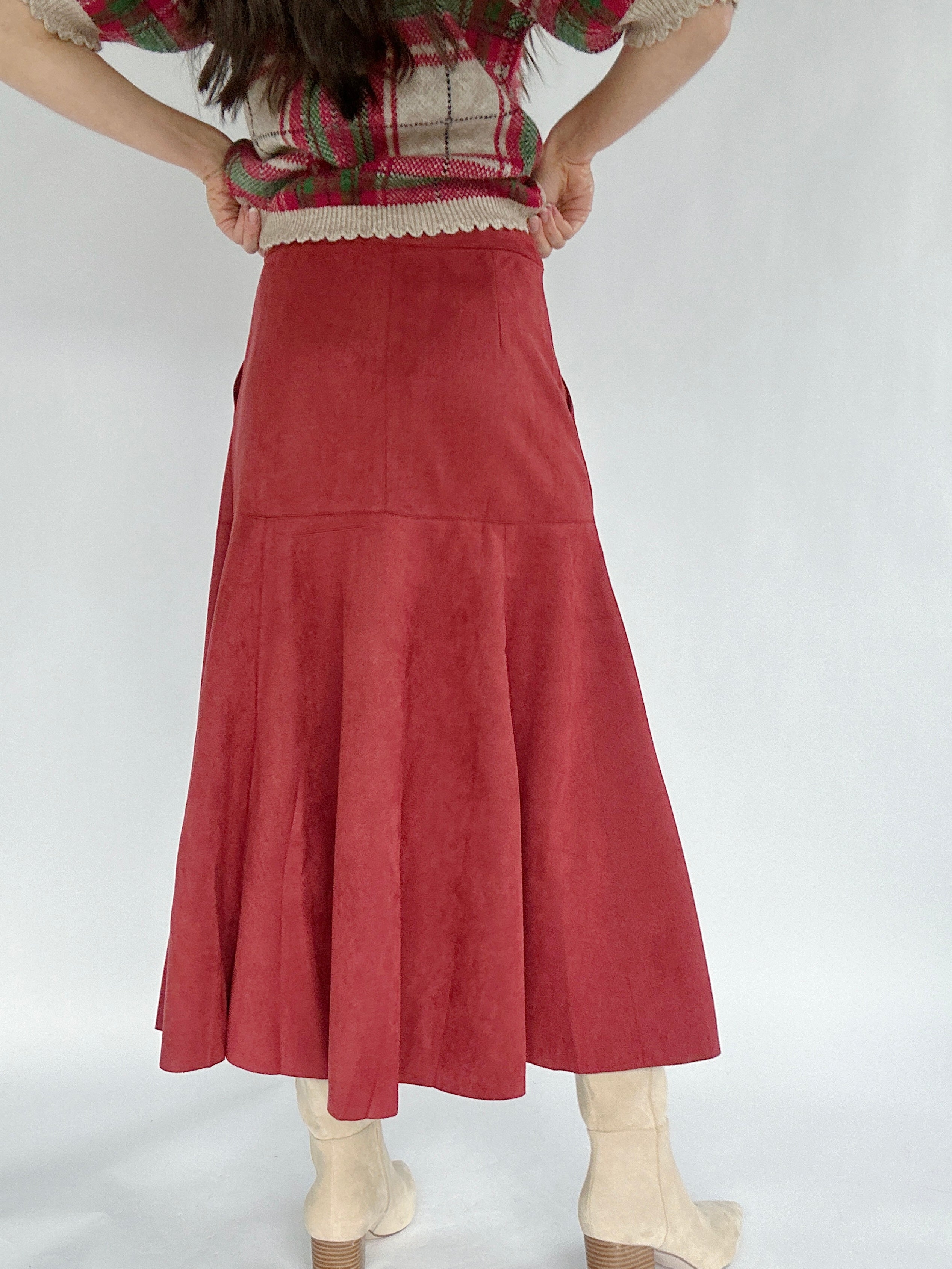Red suede skirt worn by a person on a white background back view