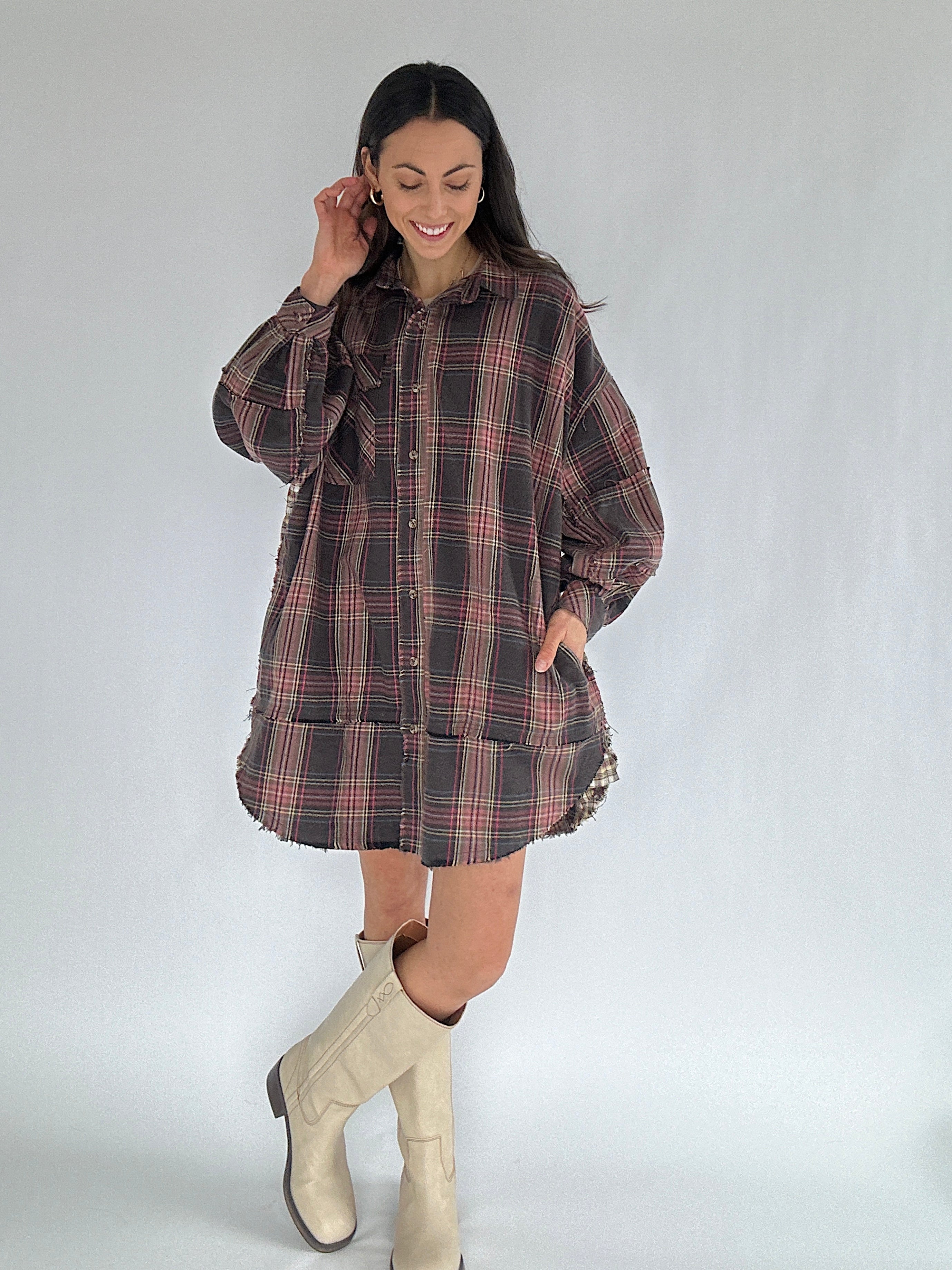 Woman wearing a plaid dress with a plain background